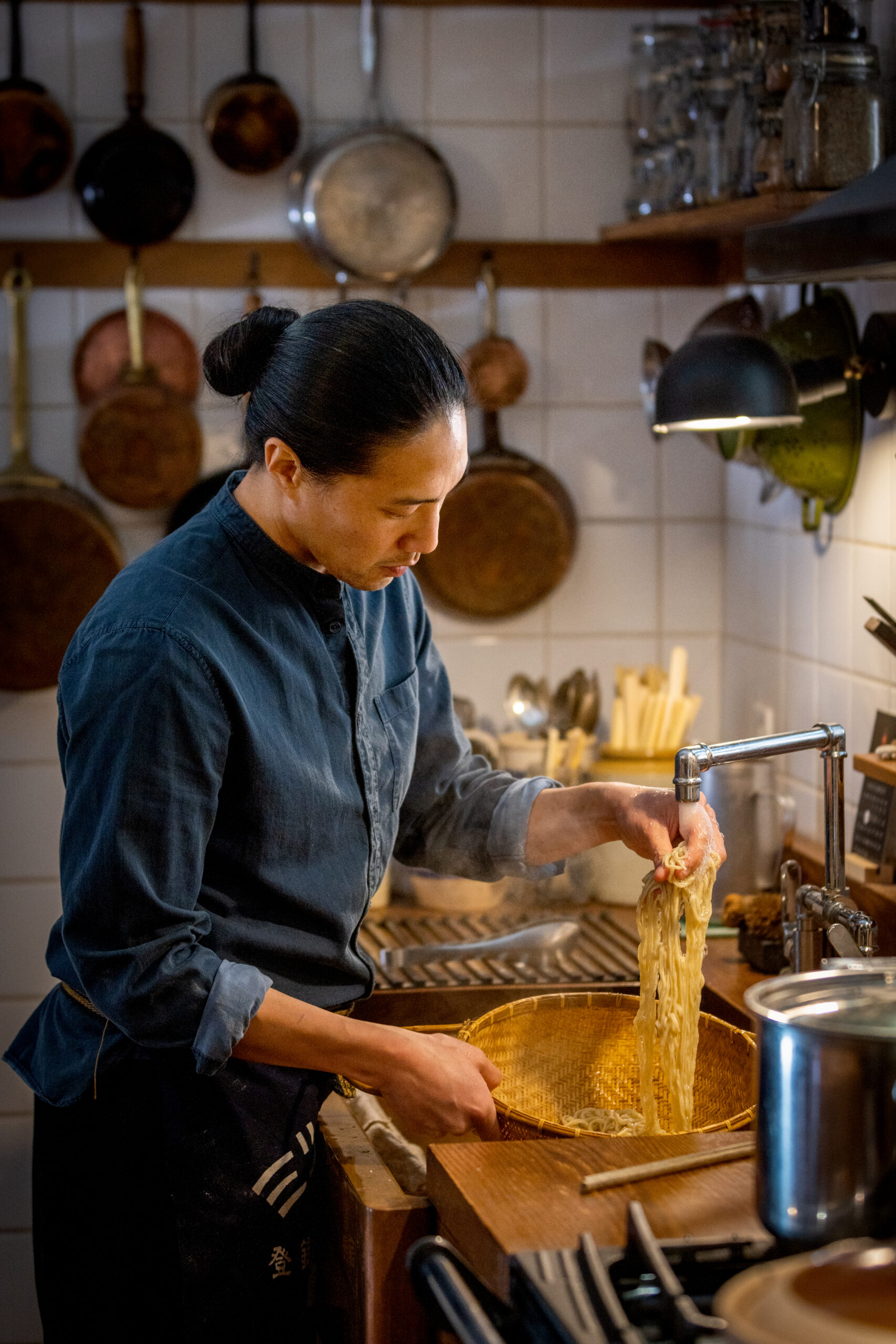 Chef Adrian Chang drains and separates the cooked noodles for his Lo Fong Tong with pork ribs and winter melon in his west county kitchen Thursday, November 10, 2022. (John Burgess/Sonoma Magazine)
