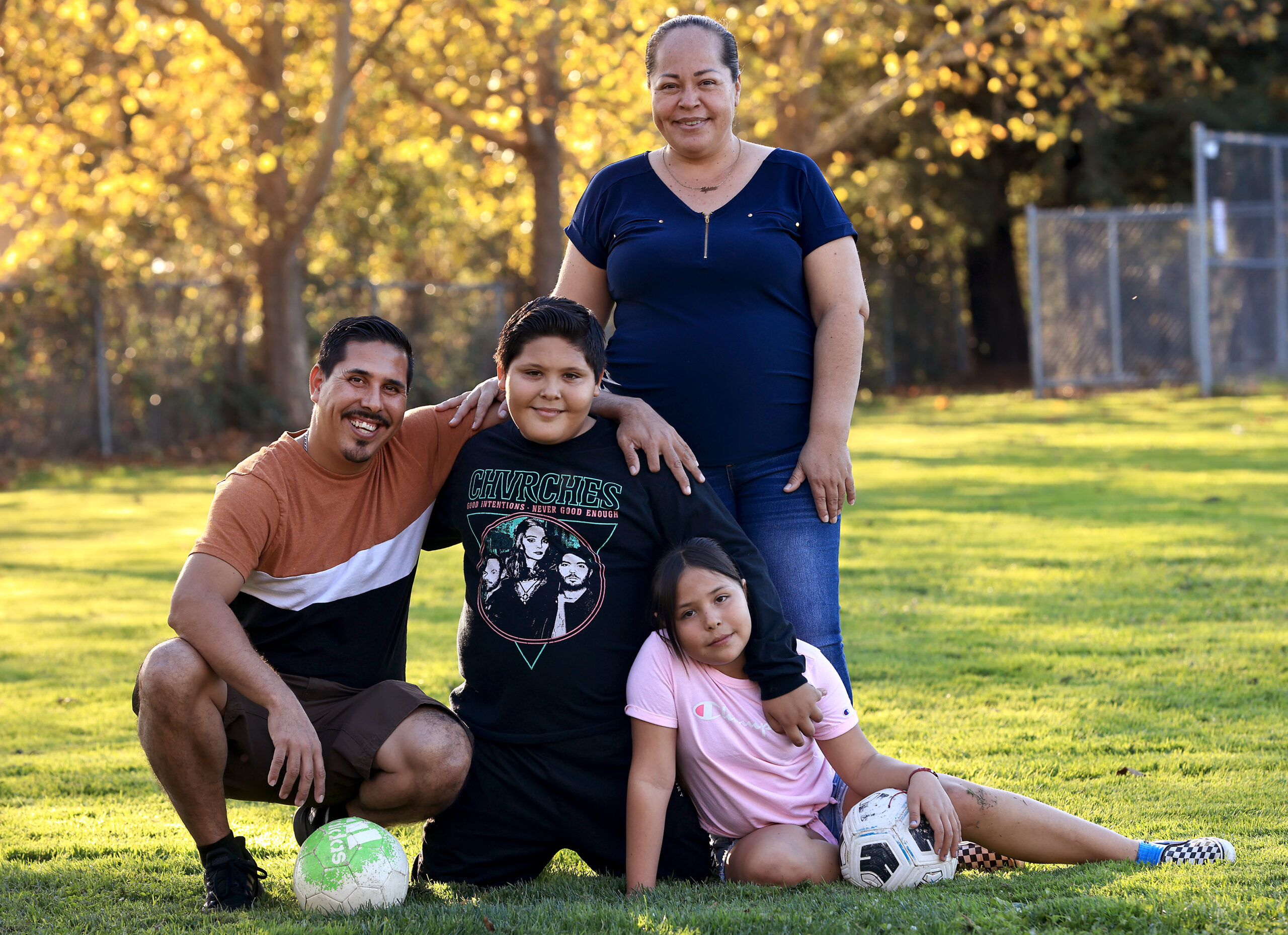 Adrian, 13, and his sister Angelique, 10, join their parents Julio Pena and Guadalupe Yesenia Espinoza for a family portrait, Wednesday, Nov. 16, 2022 in Healdsburg. The family was granted asylum, and drove through the border legally on Oct. 19 from Tepalcatepec, Michoacan in Mexico. . (Kent Porter / The Press Democrat) 2022