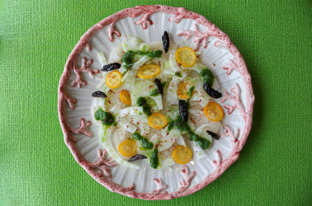 Scallop Crudo, made with fennel, kumquat, oil-cured olives, and pink peppercorn, at The Redwood in Sebastopol on Friday, February 24, 2023. (Christopher Chung/The Press Democrat)