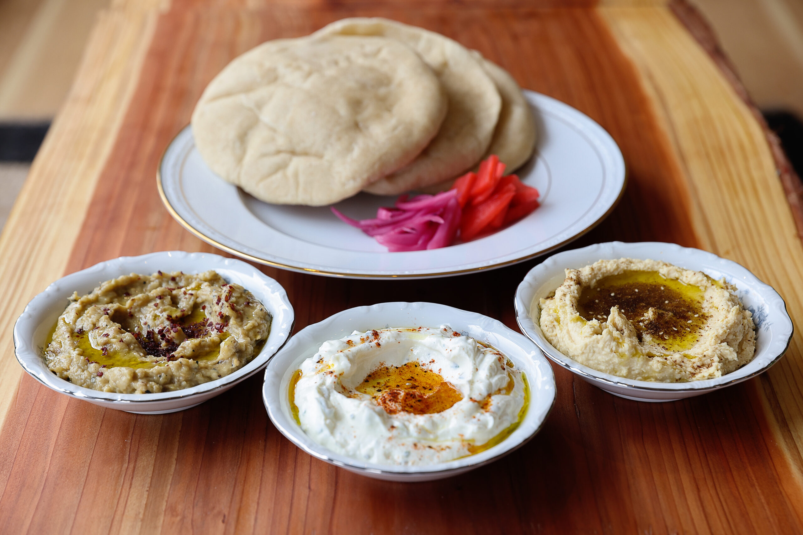 Route 1 Pita and Dip with pickled fresh vegetables, served with Chickpea Hummus with Za'atar, left, Seasoned Labneh with herbs & Baharat, and Baba Ghanoush with Sumac, at The Redwood in Sebastopol. (Christopher Chung/The Press Democrat)