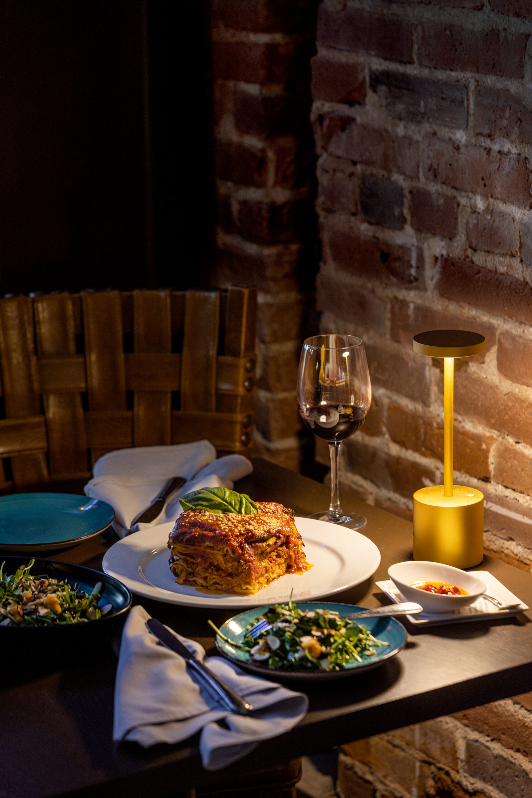 The enormous Lasagna with a Stagionale salad of arugula, roasted butternut squash puree, sliced almonds., topped with pecorino cheese, in an orange mustard and Extra Virgin Olive Oil dressing from L’oro di Napoli in downtown Santa Rosa March 24, 2023. (John Burgess/The Press Democrat)