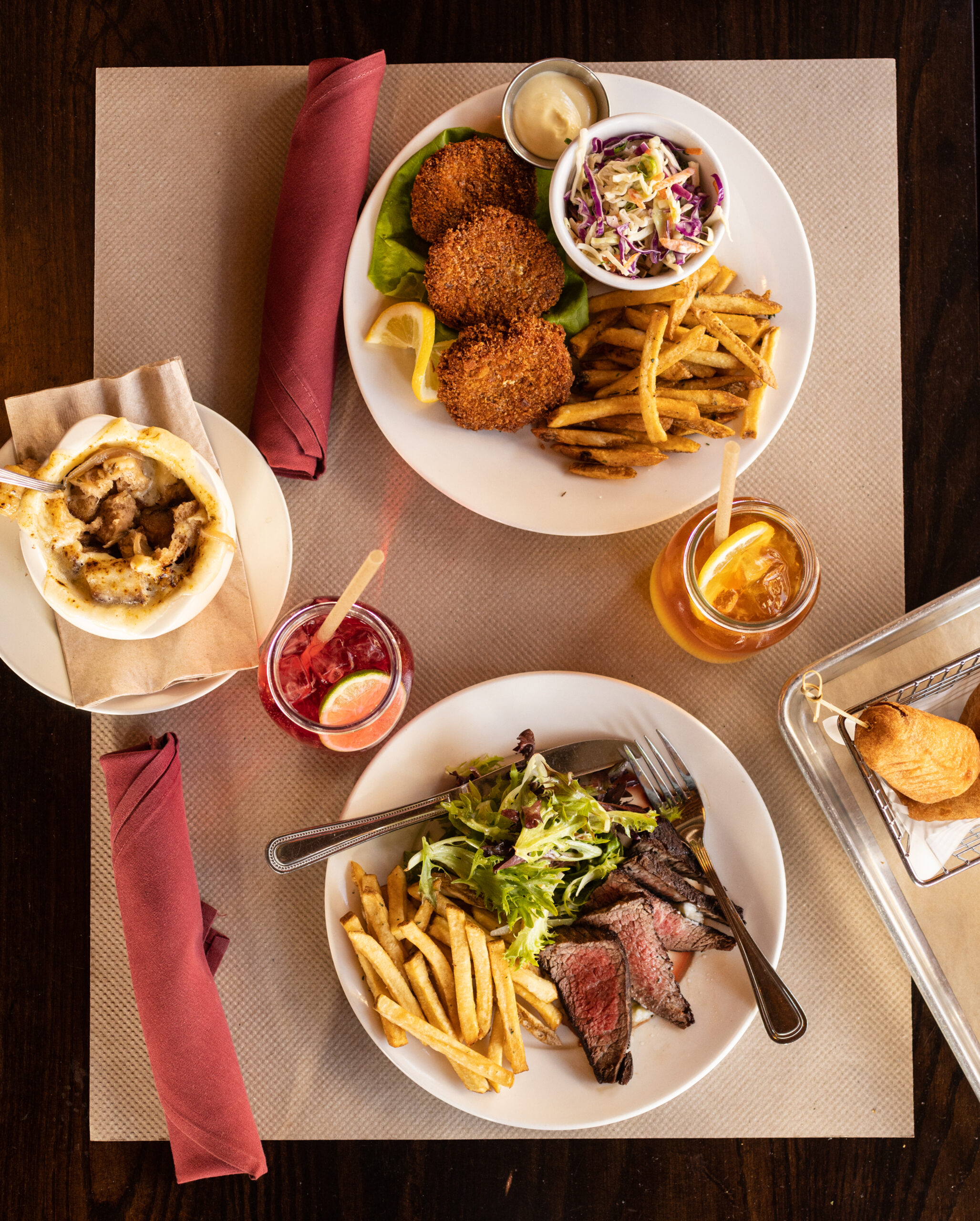 Crab Cakes and Seared Steak with sides from the new dinner menu at Americana in Santa Rosa April 13, 2023. (John Burgess/The Press Democrat)