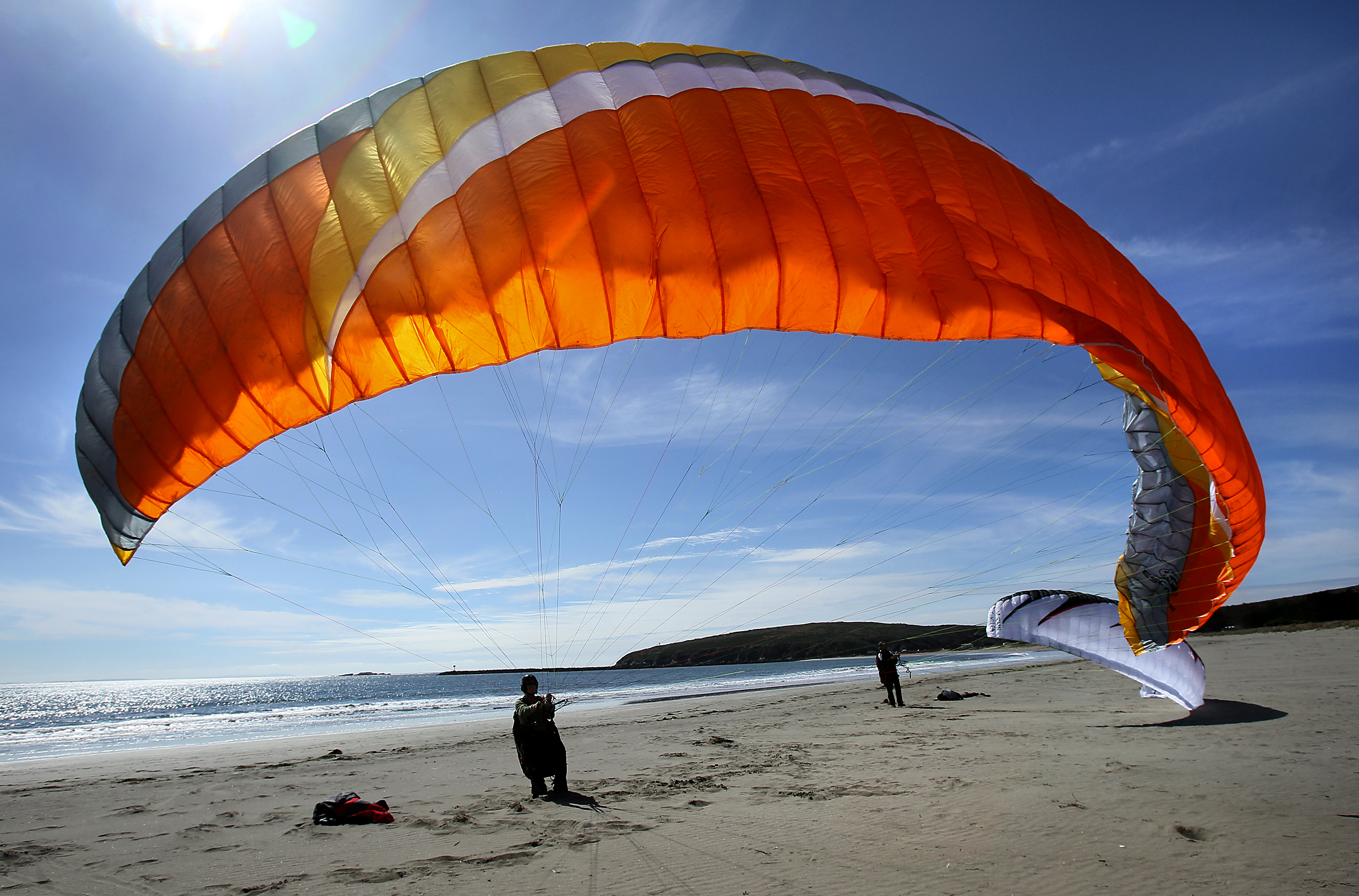 3/2/2011: A1: PC: Rebecca Pennington, left, of Sebastopol and Cody Richardson practice paragliding at Doran Beach Regional Park on Tuesday morning. Pennington buys an annual pass and Richardson will also purchase one when he moves to the area.
