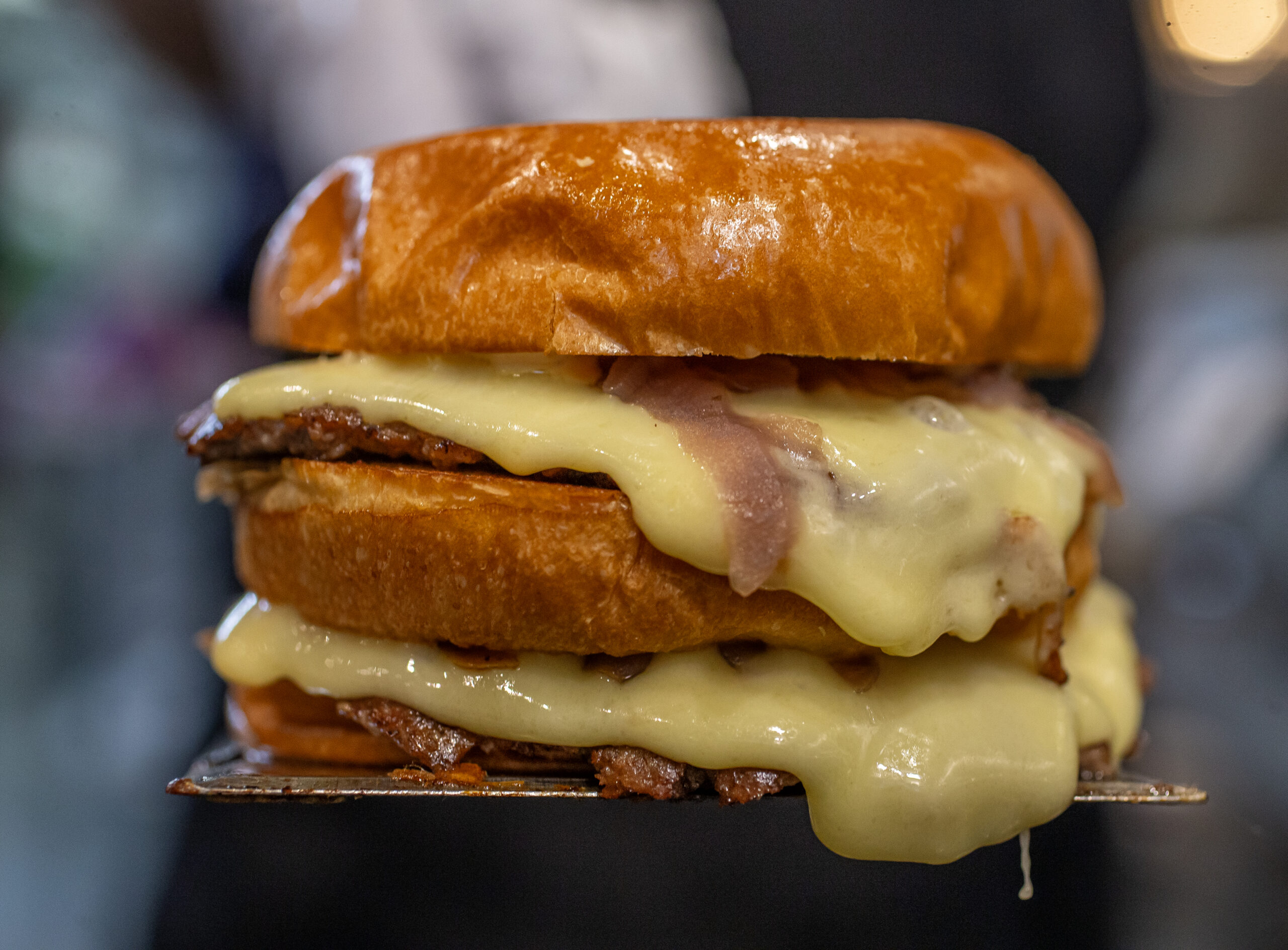 Iggy’s Organic Burgers with duck fat and beef patty, buttery brioche, organic American cheese, ketchup, mustard, onions caramelized with a secret sauce, and pickles are served on the plaza, Friday in Downtown Healdsburg June 30, 2023. (Chad Surmick / The Press Democrat)