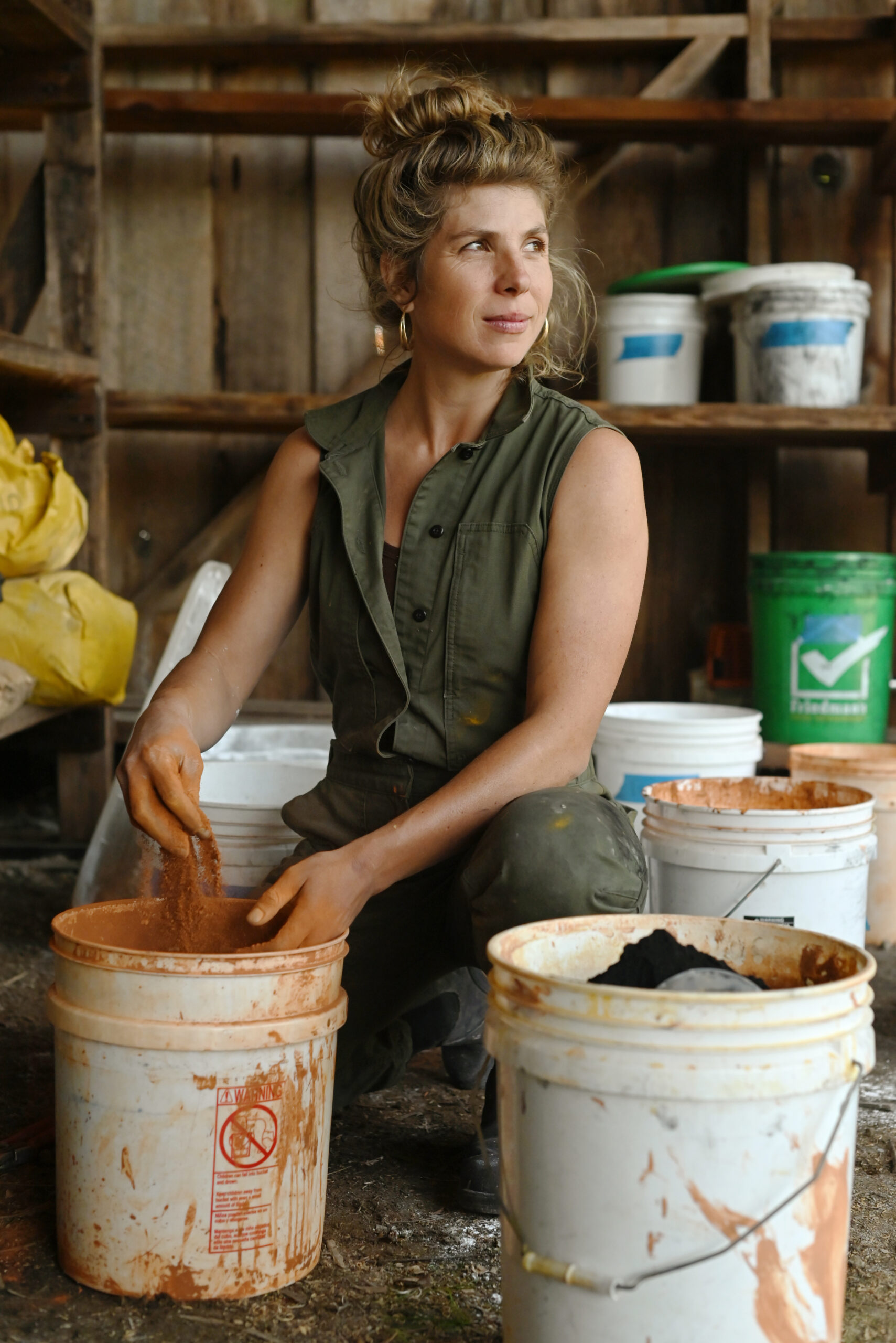 Anderson mixes her natural pigments by hand. The pigments are designed to break down soon after application. Iron oxide, clay, and calcium carbonate work to nourish the soil as they break down. (Erik Castro)