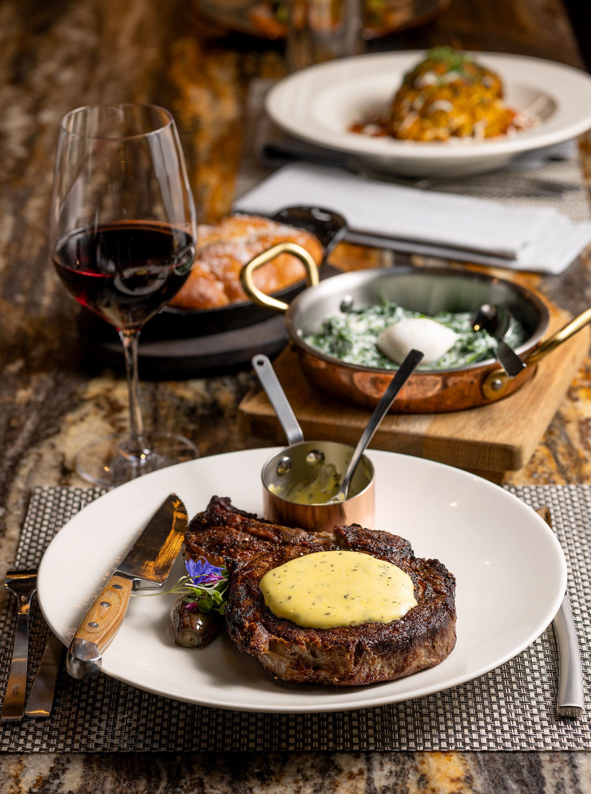 The 25 oz. Ribeye Steak with bernaise sauce, with a side of Creamed Spinach and Parker House Rolls from Goodnight’s Prime Steak + Spirits Friday, August 11, 2023 on the square in Healdsburg. (Photo John Burgess/The Press Democrat)