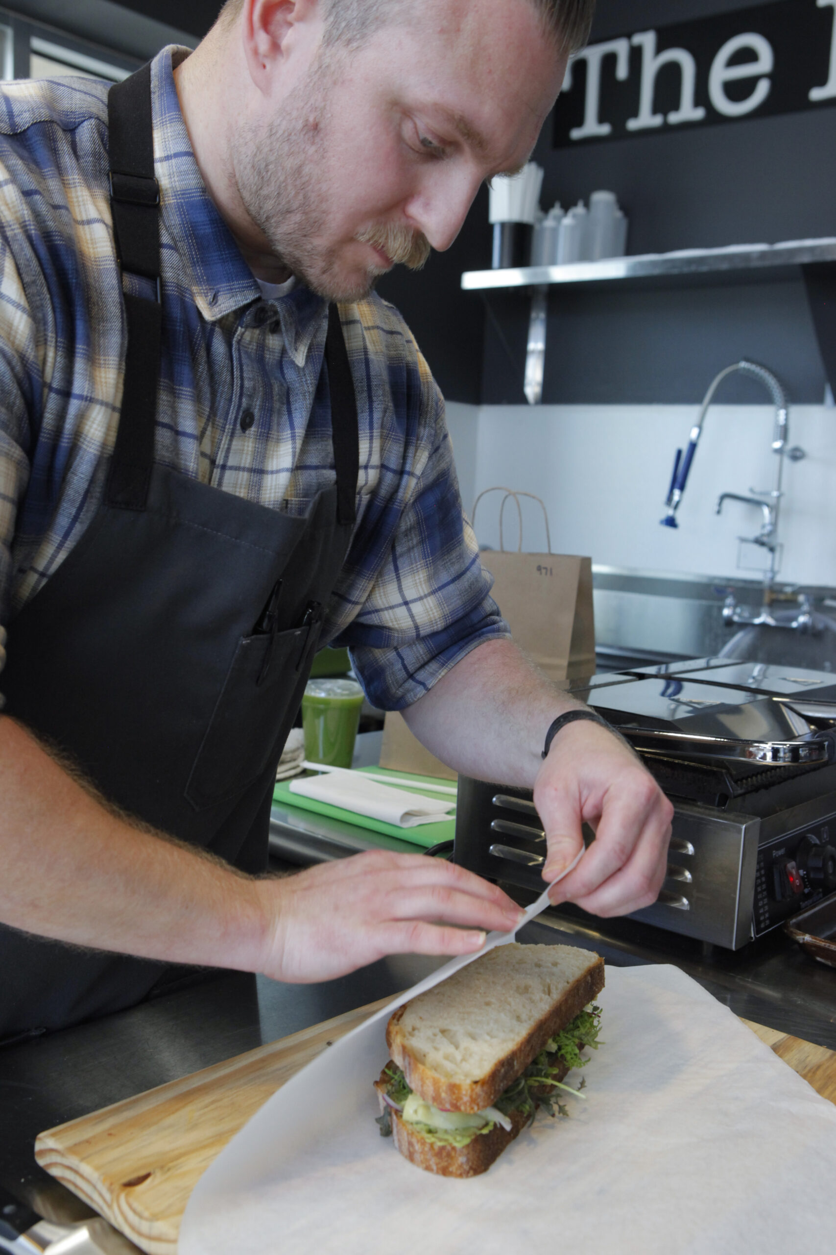 Chris Osborne wraps a sandwich at The Local, a café located inside the Active Gym in Petaluma._ Tuesday, April 25, 2023. _(CRISSY PASCUAL/ARGUS-COURIER STAFF)