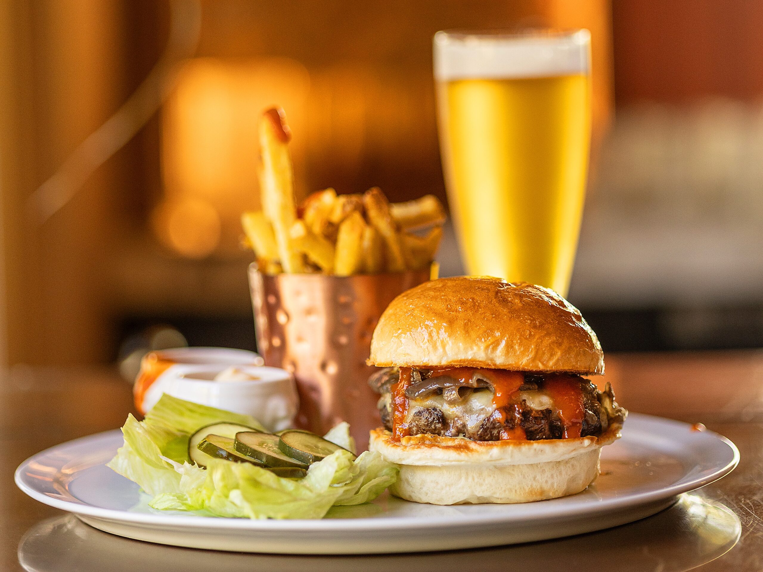 The Madrona Burger with roasted onions, white Cheddar cheese, spicy ketchup and beef fat fries from the weekend brunch menu at The Madrona in Healdsburg, Friday, July 14, 2023. (John Burgess / The Press Democrat)