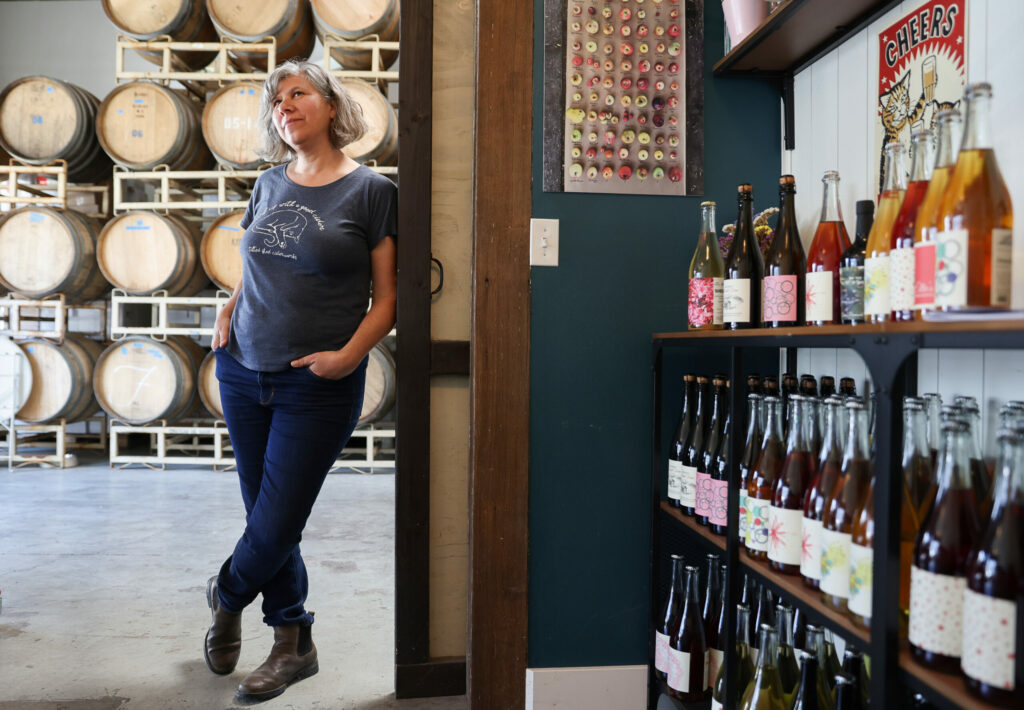 Tilted Shed Ciderworks co-owner Ellen Cavalli and her husband, Scott Heath, created Ellies Non-Alcoholic Cider after she was told to reduce her alcohol intake when she was diagnosed with breast cancer. Photo taken at the Tilted Shed Ciderworks tasting room in Windsor on Thursday, April 20, 2023. (Christopher Chung/The Press Democrat)