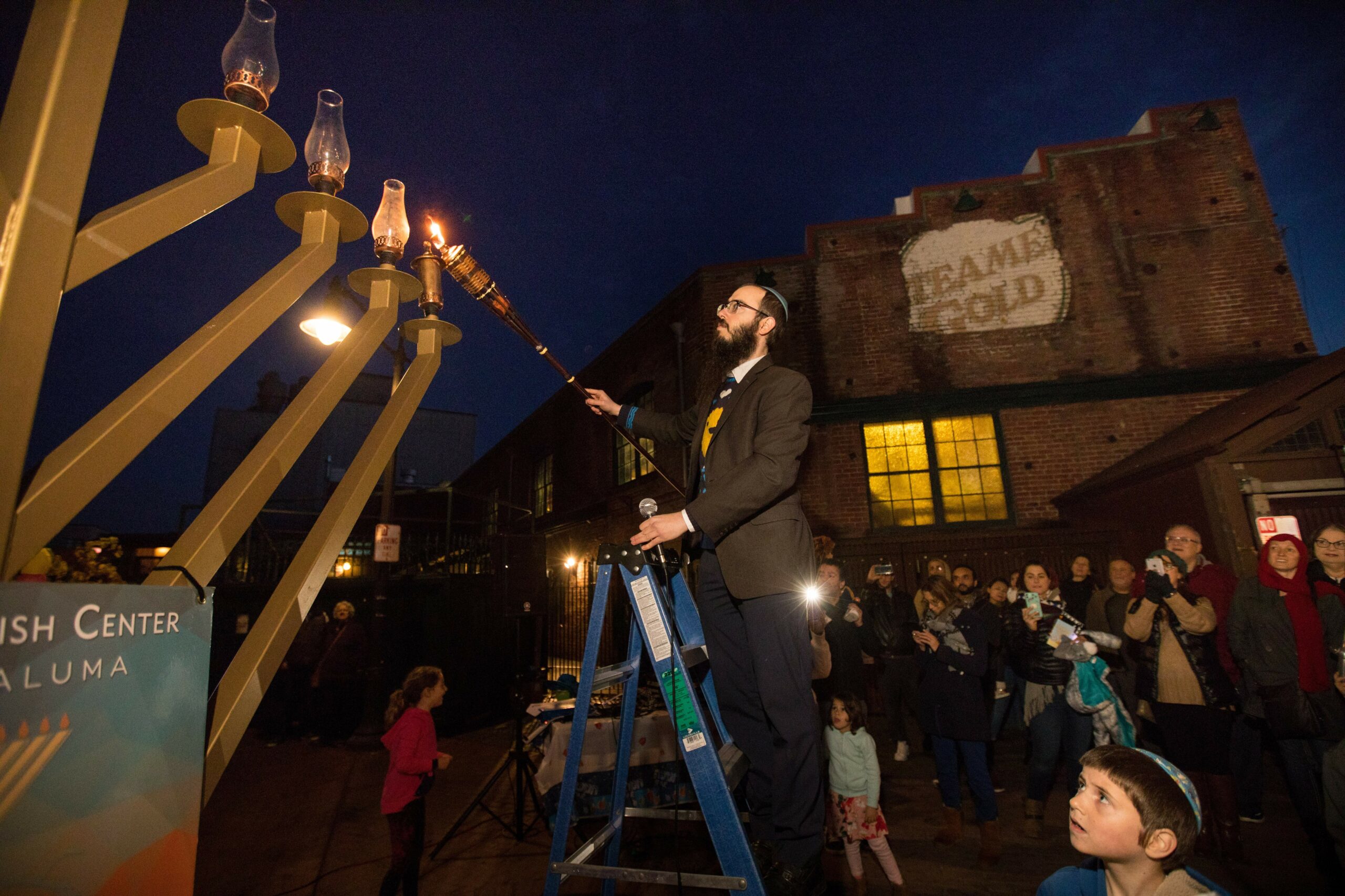 Rabbi Dovid Bush, of Chabad Jewish Center, lights the first candle of the Grand Menorah, at the 5th Annual Chanukah at the River celebration presented by Chabad Jewish Center on Sunday, December 22, 2019, in Petaluma, California. (Photo by Darryl Bush / For The Press Democrat)