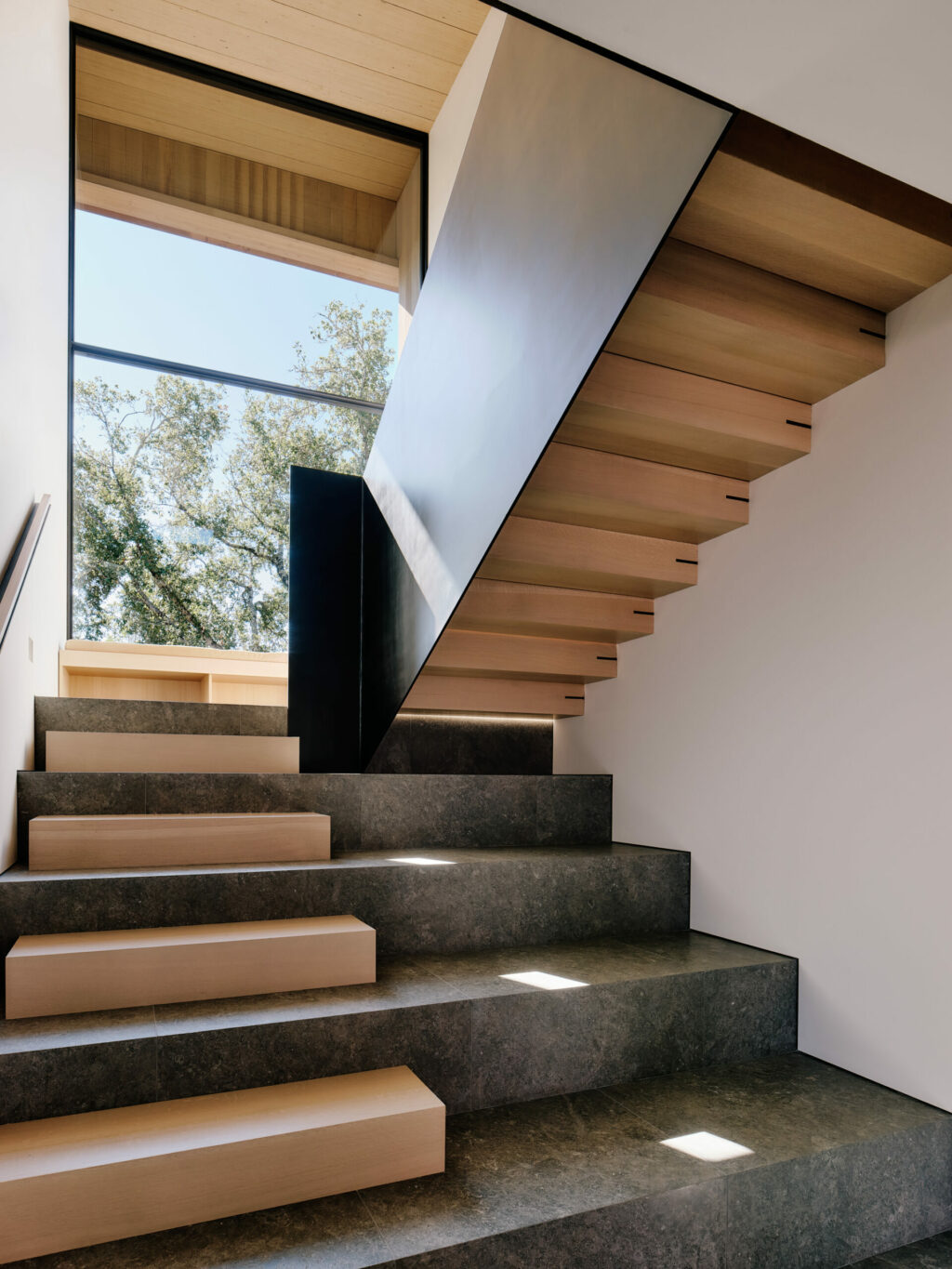 Staircase with interplay of wood and stone elements.  (Joe Fletcher)