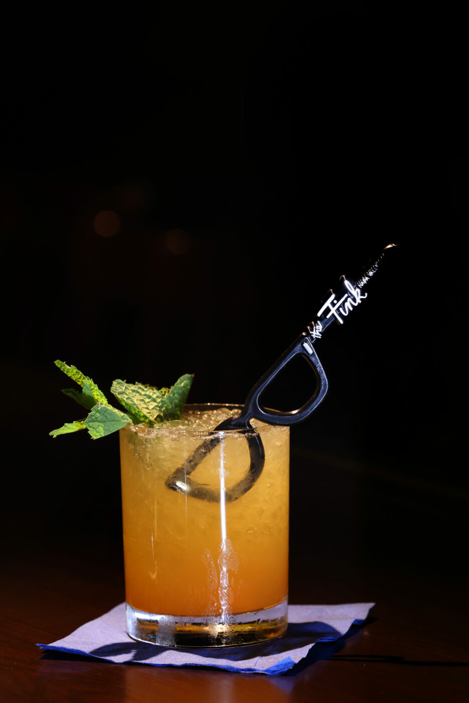 The cocktail Iuka's Grog includes dark Jamaican rum, Demerara rum, lime, pineapple and passionfruit juices, and a signature "The Fink" swizzle stick at The Fink, a new craft cocktail bar with the theme of an old boathouse in Napa, Wednesday, July 26, 2023. (Beth Schlanker / The Press Democrat)
