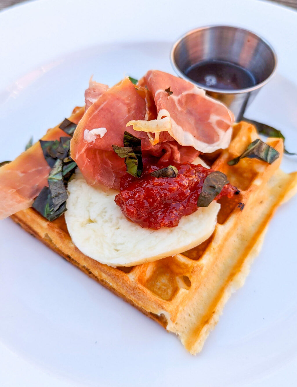 A savory Belgian waffle is topped with prosciutto and ricotta cheese at the Geyserville Gun Club brunch from Chef Kristine Gallagher. (Courtesy photo)