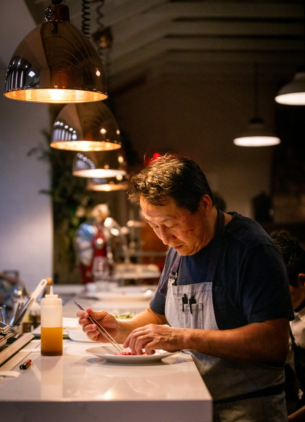 Owner Joshua Smookler finishes and checks each plate before delivering to the tables at the Golden Bear Station Thursday, January 11, 2023 on Hwy 12 in Kenwood. (Photo John Burgess/The Press Democrat)