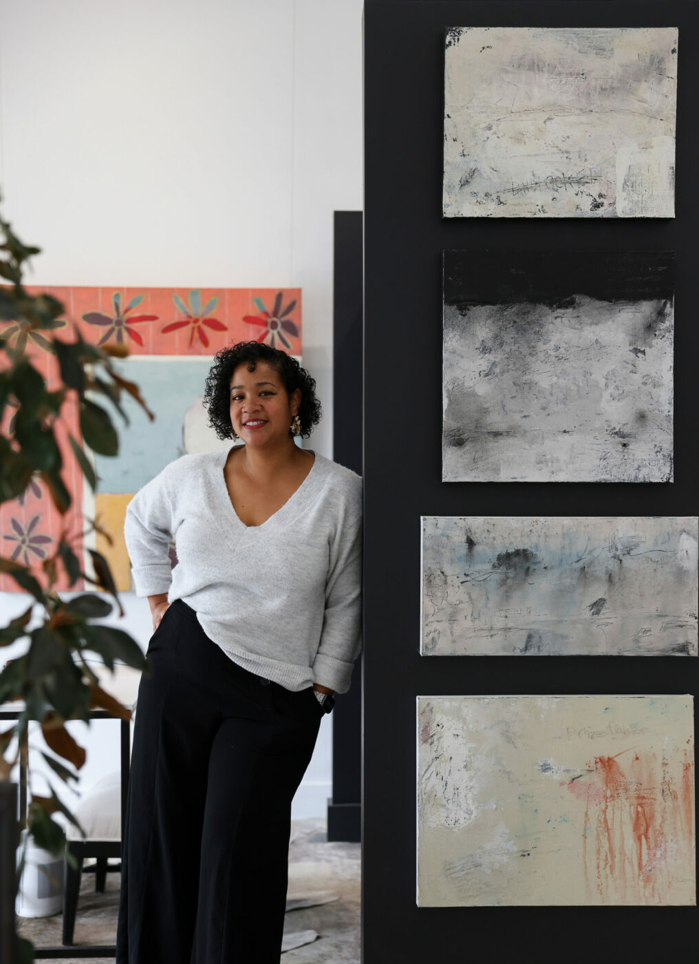 Rena Charles poses for a portrait in her Rena Charles Gallery, next to works by artist Aaron Webb, in Healdsburg on Wednesday, January 24, 2024. (Christopher Chung/The Press Democrat)