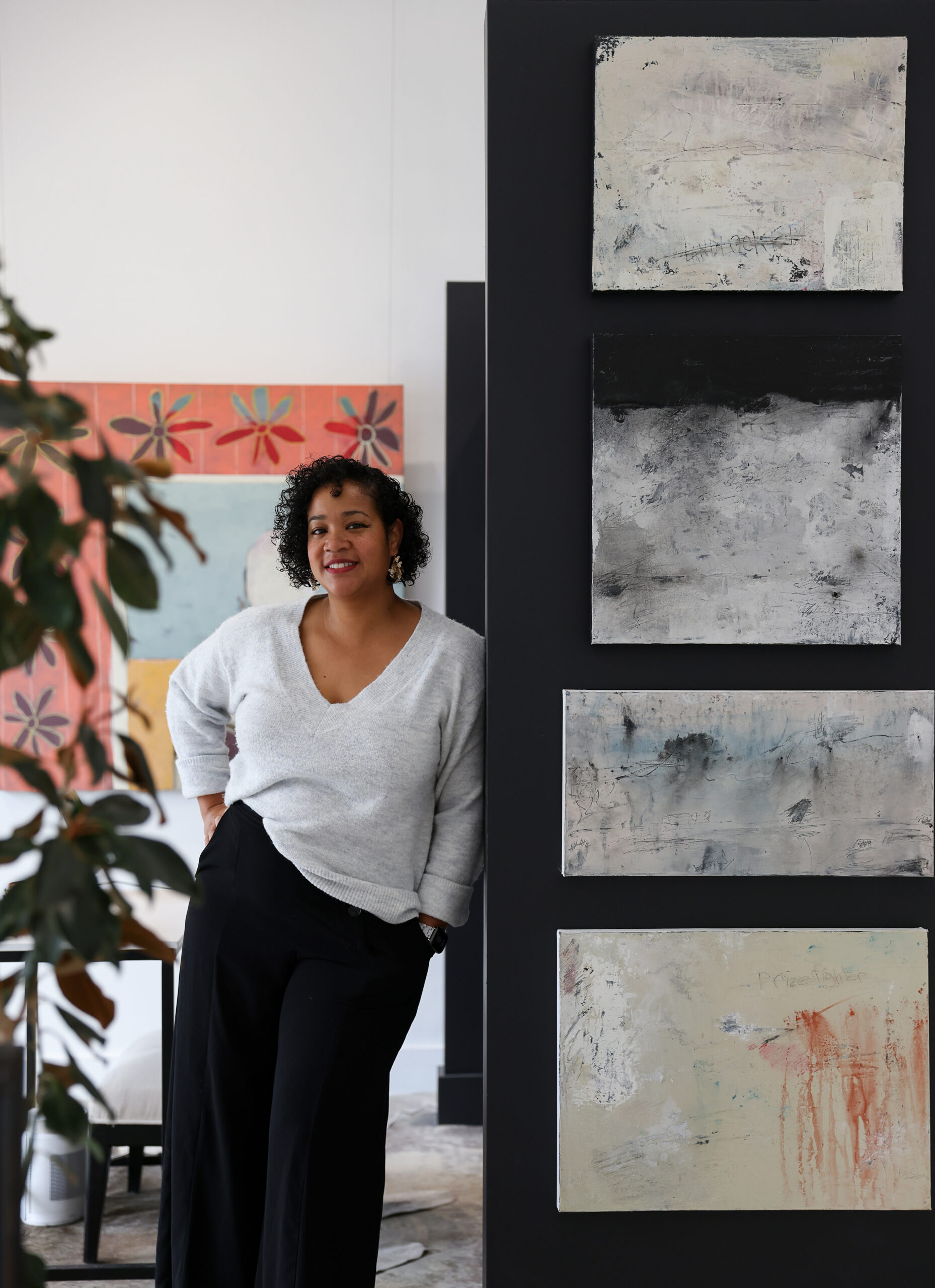 Rena Charles in her Rena Charles Gallery, next to works by artist Aaron Webb, in Healdsburg on Wednesday, January 24, 2024. (Christopher Chung/The Press Democrat)