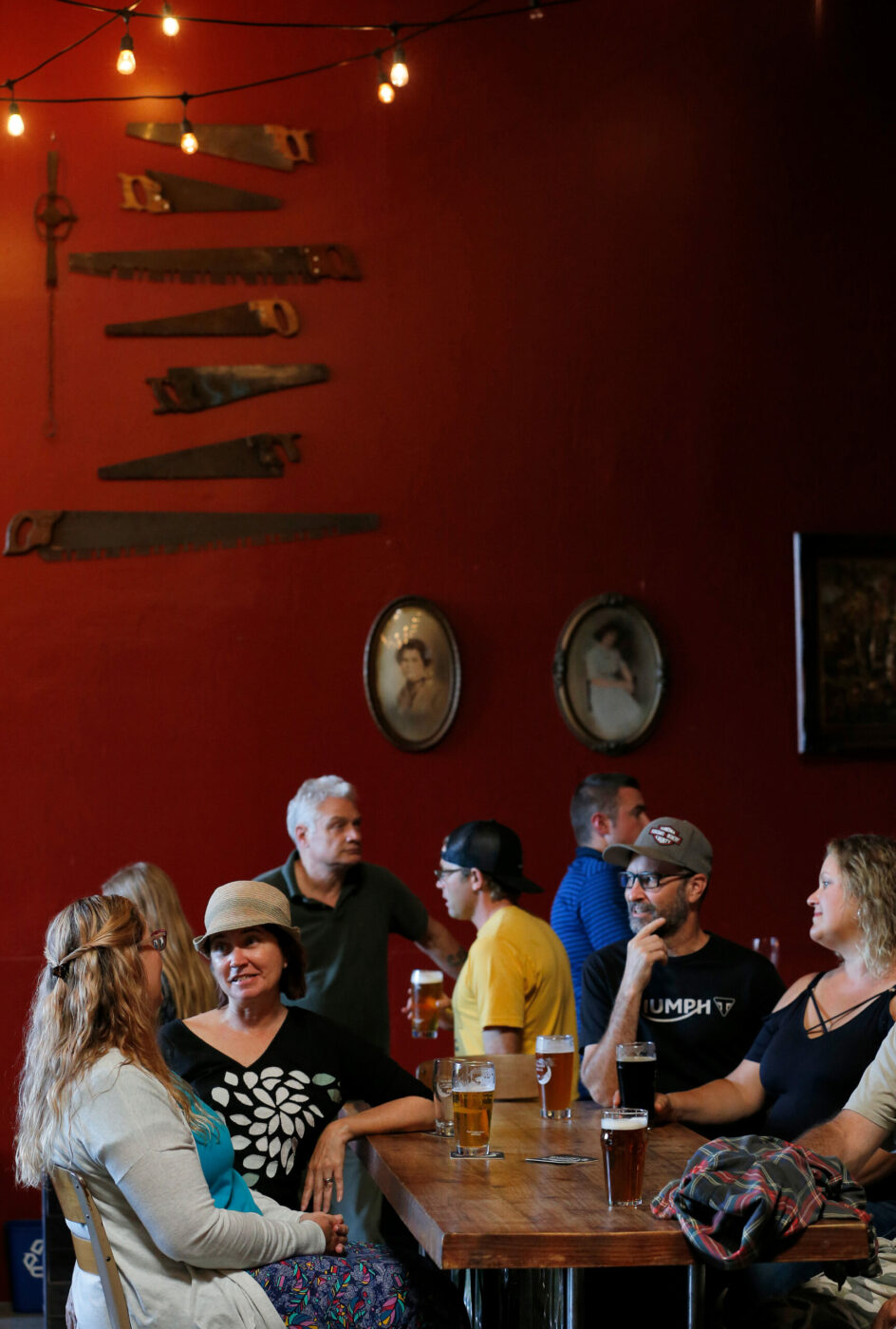Customers enjoy craft brews, conversation and live music at Moonlight Brewing Company in Santa Rosa, California, on Thursday, July 18, 2019. (Alvin Jornada / The Press Democrat)