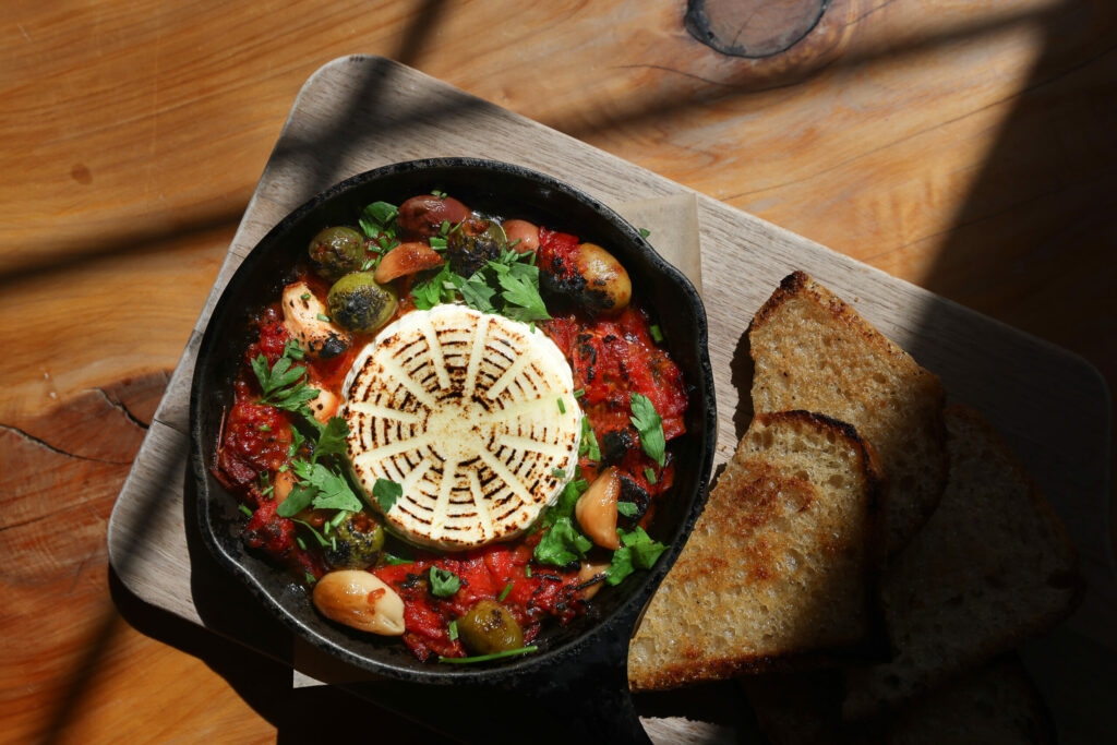 Ricotta surrounded with an olive and tomato dip at Valley Ford Cheese & Creamery in Valley Ford. (Christopher Chung / The Press Democrat)