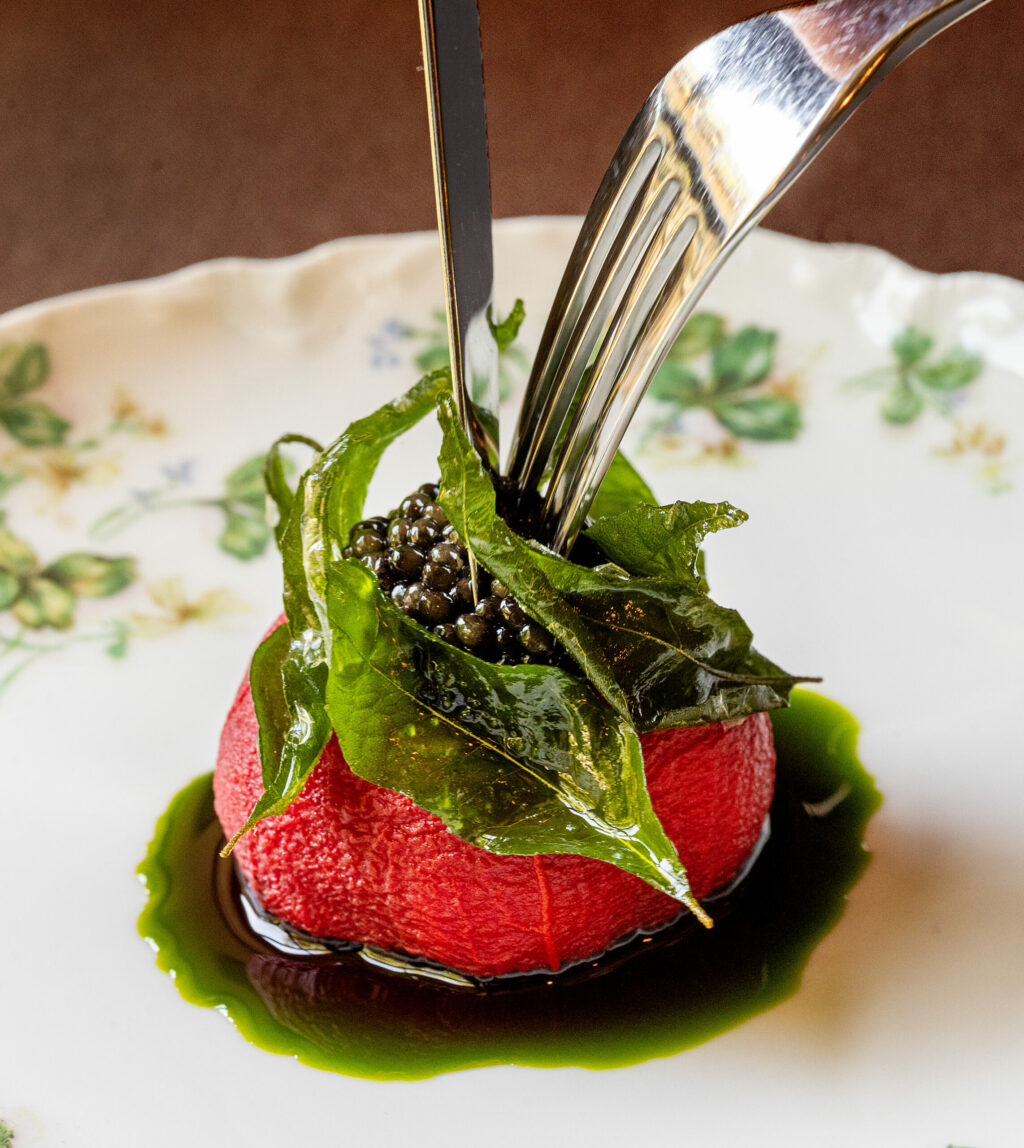Dried Early Girl Tomato inflated with mozzarella espuma over basil oil and topped with caviar and fried curry leaf from chef Craig Wilmer at the Farmhouse restaurant on River Road in Forestville, Friday, Aug. 18, 2023. (John Burgess / The Press Democrat)