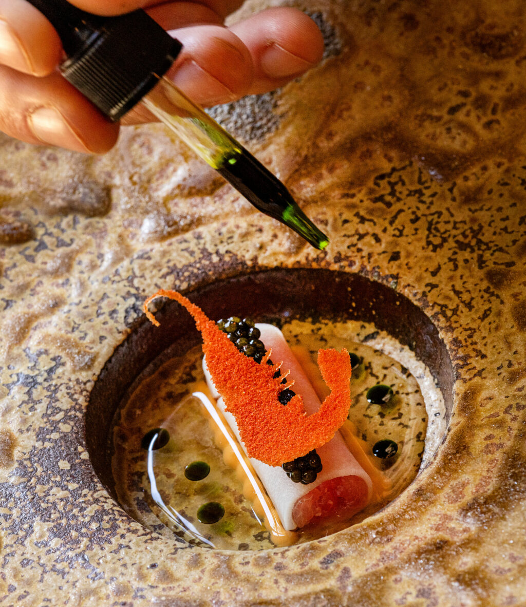 Prawn Tartar wrapped in heart of palm with a tomatoes oil and drops of dill oil from chef Craig Wilmer at the Farmhouse restaurant on River Road in Forestville, Friday, Aug. 18, 2023. (John Burgess / The Press Democrat)