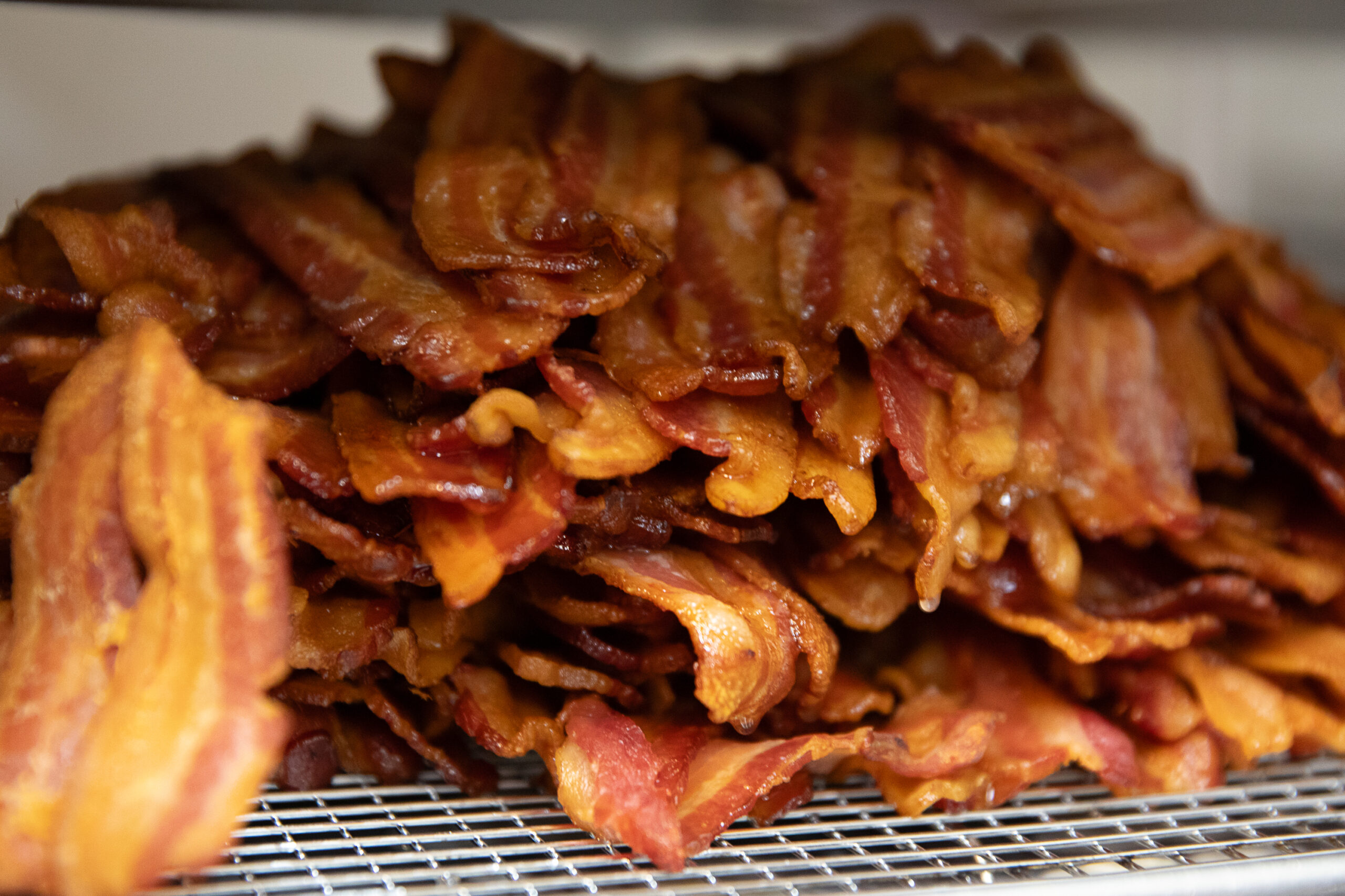 Cooked bacon for breakfast sandwiches at Criminal Baking in Santa Rosa on March 24, 2024. (Kathryn Styer Martínez)