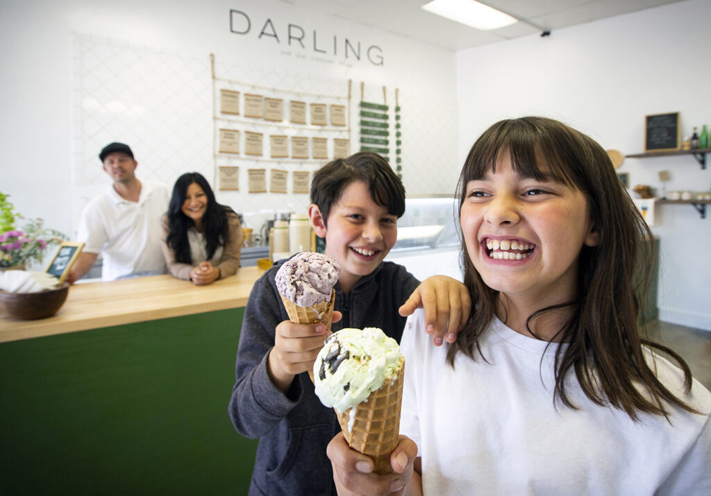 Mila, 9, and her brother Caden, 10, enjoy an ice cream cone at their parents, Joe and Ramie Hencmannís newest ice cream shop venture, Darling, located in the Sonoma Marketplace shopping center on West Napa Street. (Photo by Robbi Pengelly/Index-Tribune)