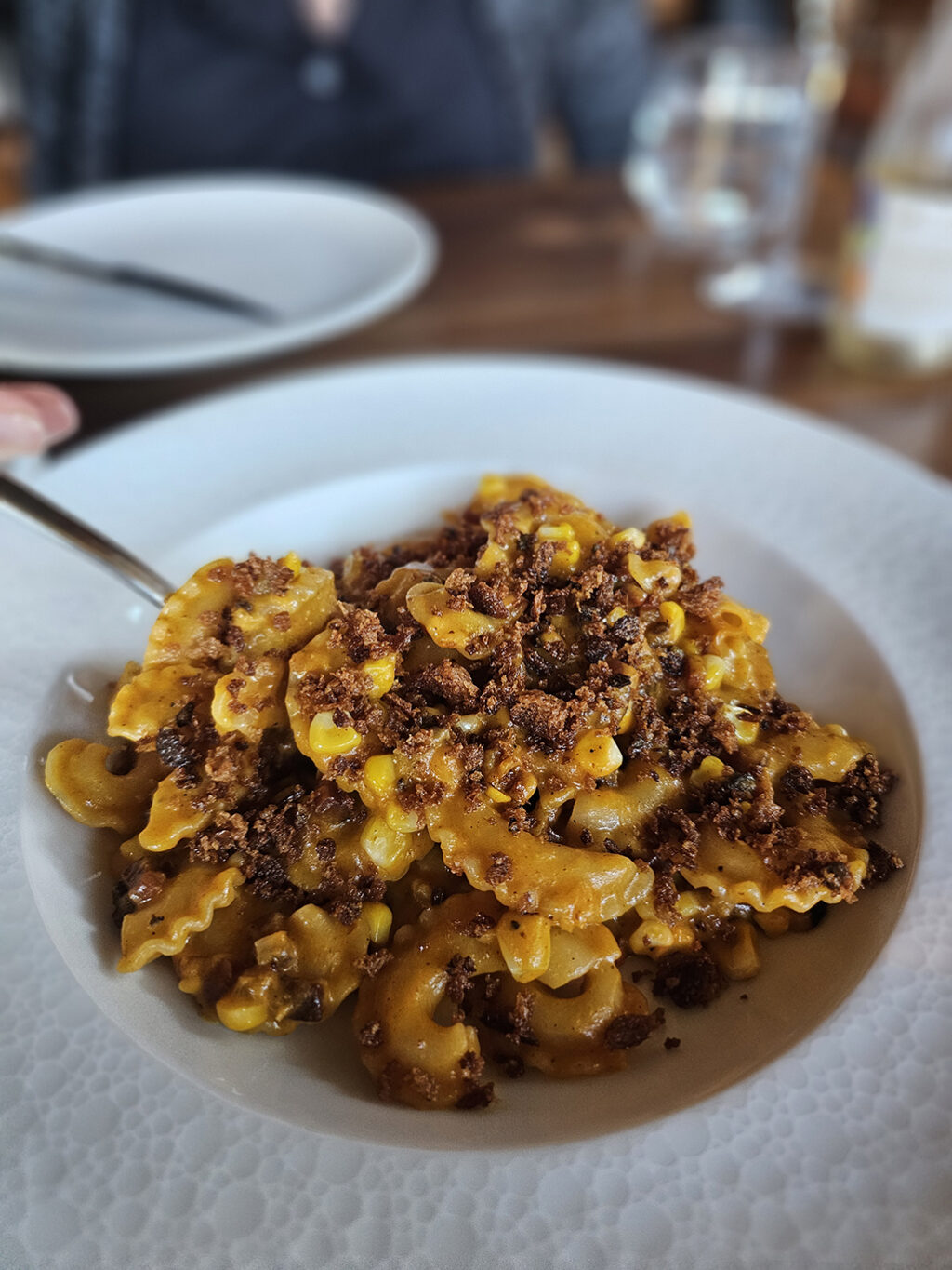 Creste di gallo Pomodoro, cock’s comb-shaped pasta with crisp guanciale, orange tomato and sweet corn. at Folia at Appellation in Healdsburg. (Heather Irwin/Sonoma Magazine)