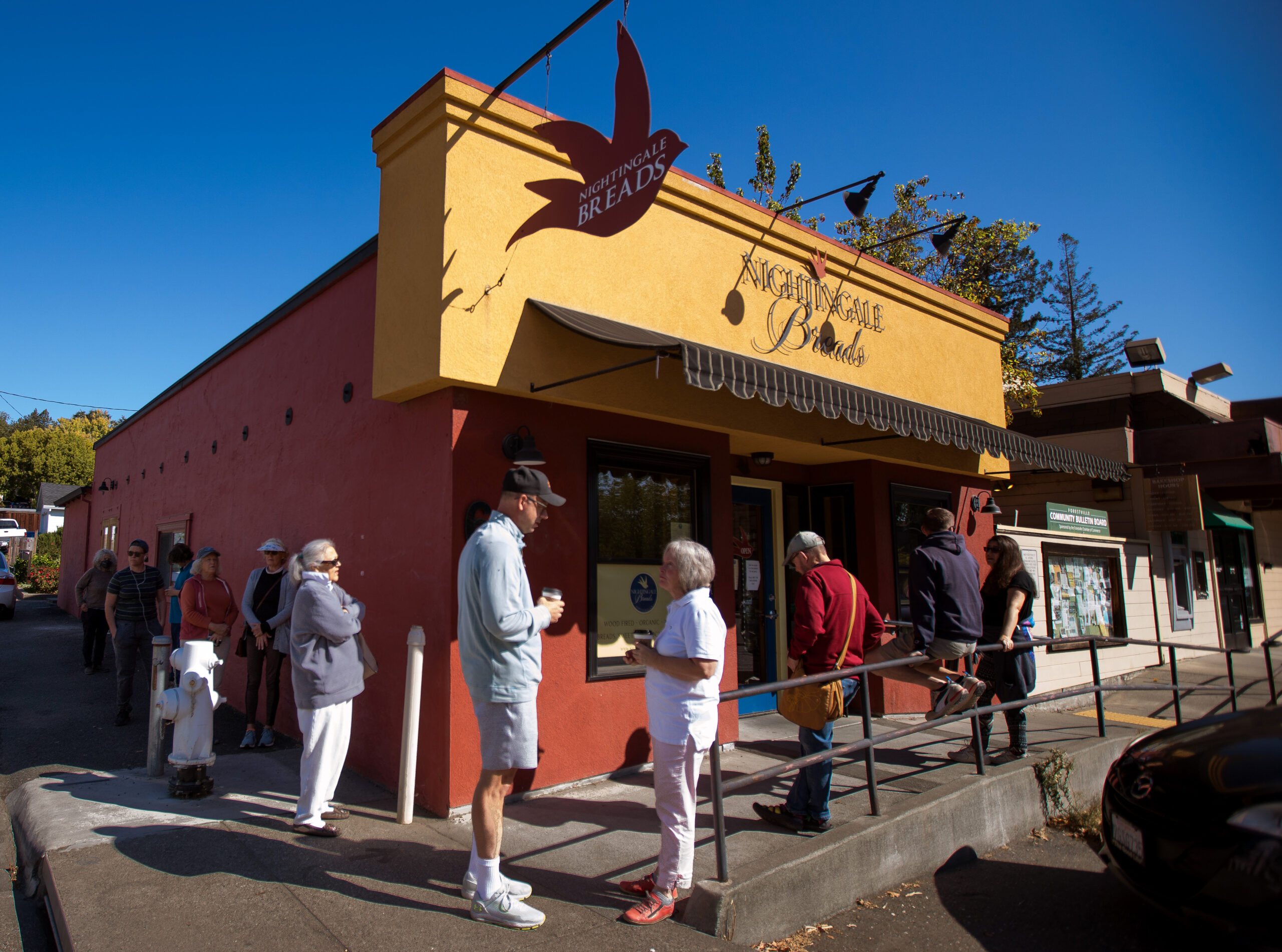Customers wait in line outside Nightingale Breads, Sunday, Oct. 9, 2022, in Forestville. (Darryl Bush / For The Press Democrat)