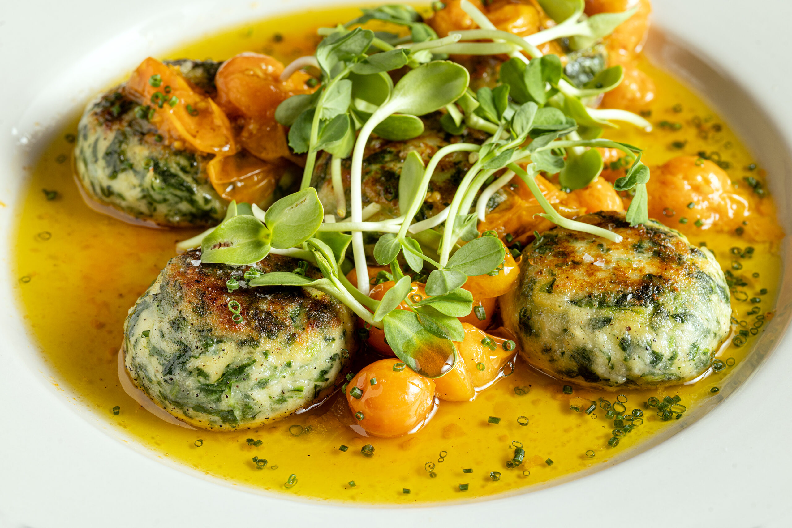 Ricotta and arugula gnudi, oil-cured Oak Hill cherry tomato, red onion confiture from Songbird Parlour restaurant