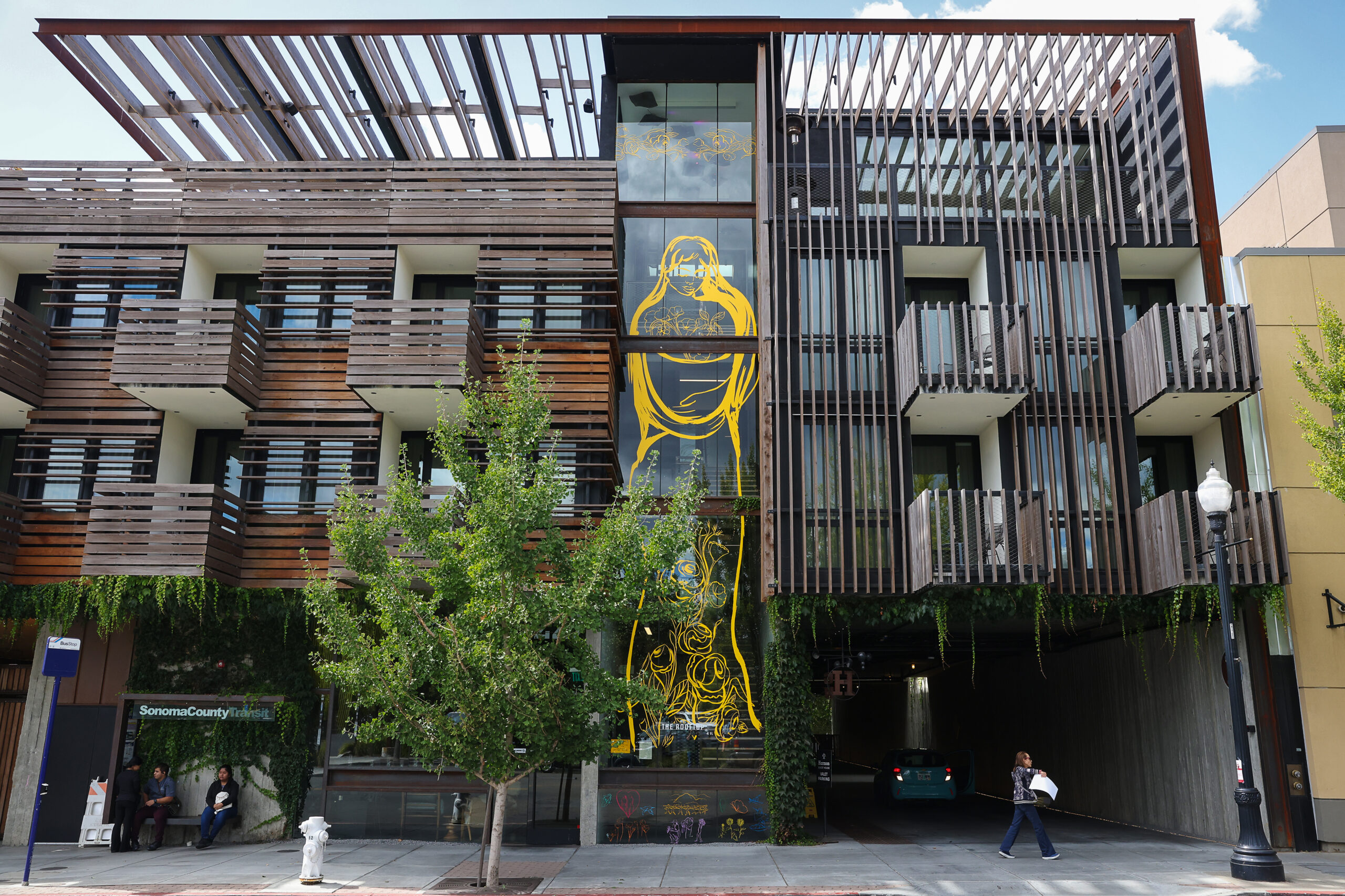 Maria de Los Angeles' art piece “Mi Healdsburg-My Healdsburg” spans four stories on Harmon Guest House in Healdsburg on Monday, September 16, 2024. (Christopher Chung/The Press Democrat)