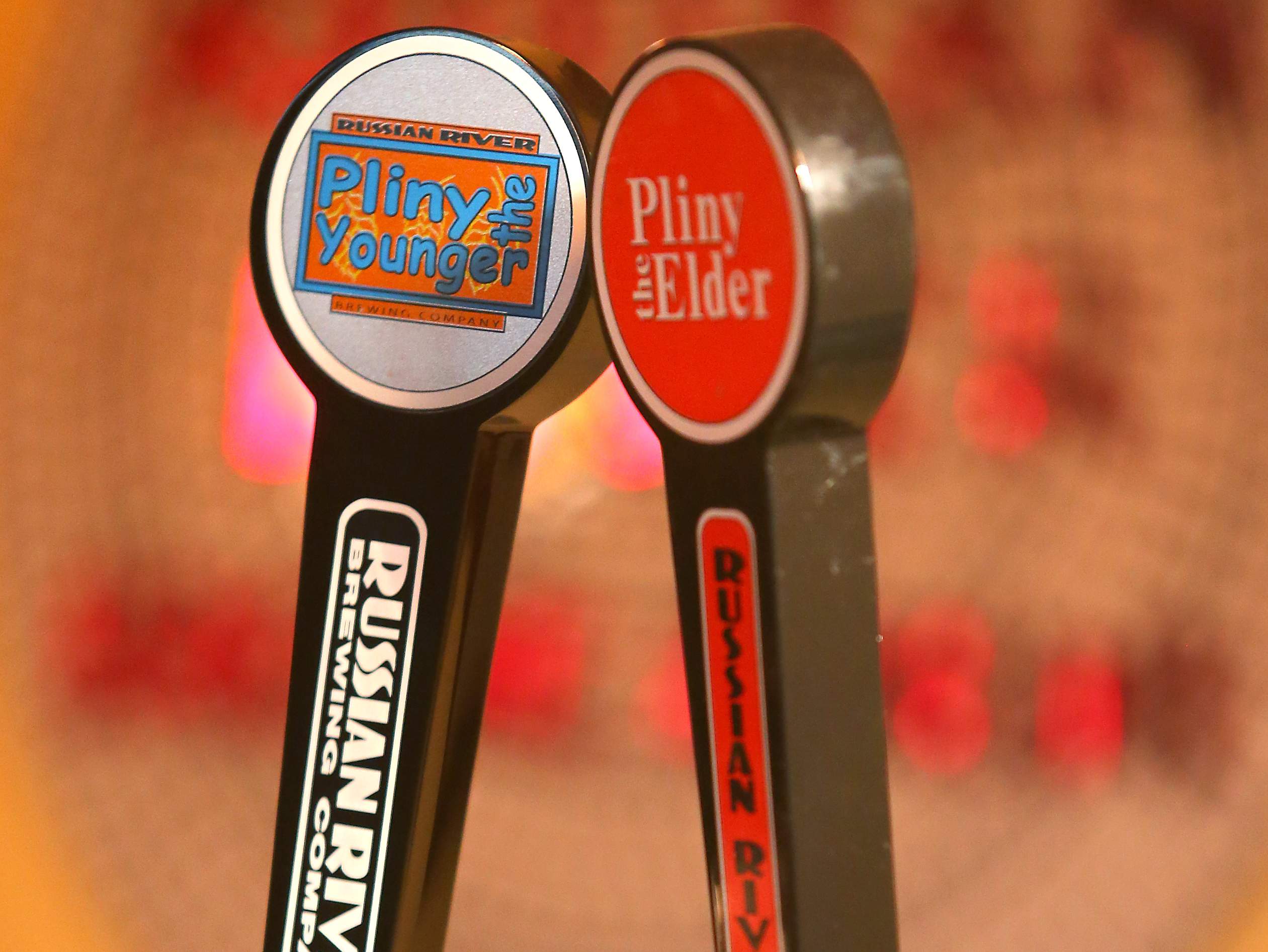 Tap handles for Pliny the Younger and Pliny the Elder in the tasting room at the Russian River Brewing Company production facility in Santa Rosa. (Christopher Chung/ The Press Democrat)