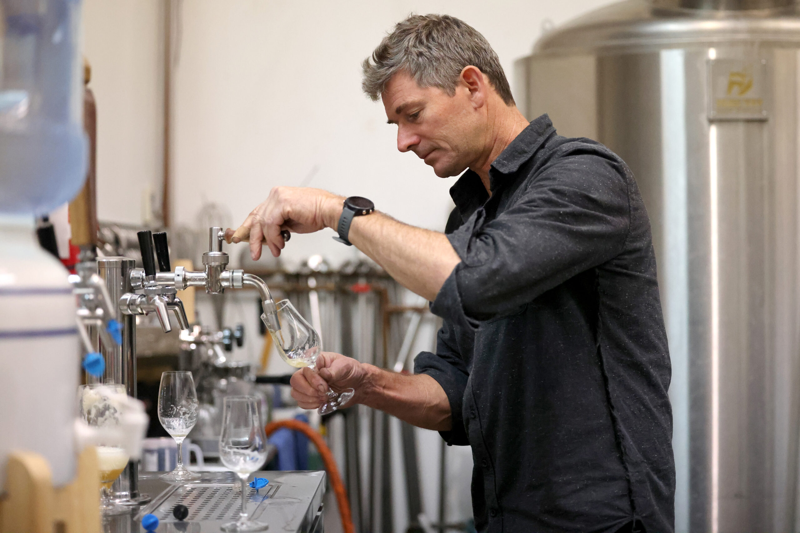 Mad Fritz Brewing Company cofounder Nile Zacherle pours a beer on tap at the brewery in St. Helena, Monday, Nov. 13, 2023. (Beth Schlanker / The Press Democrat)