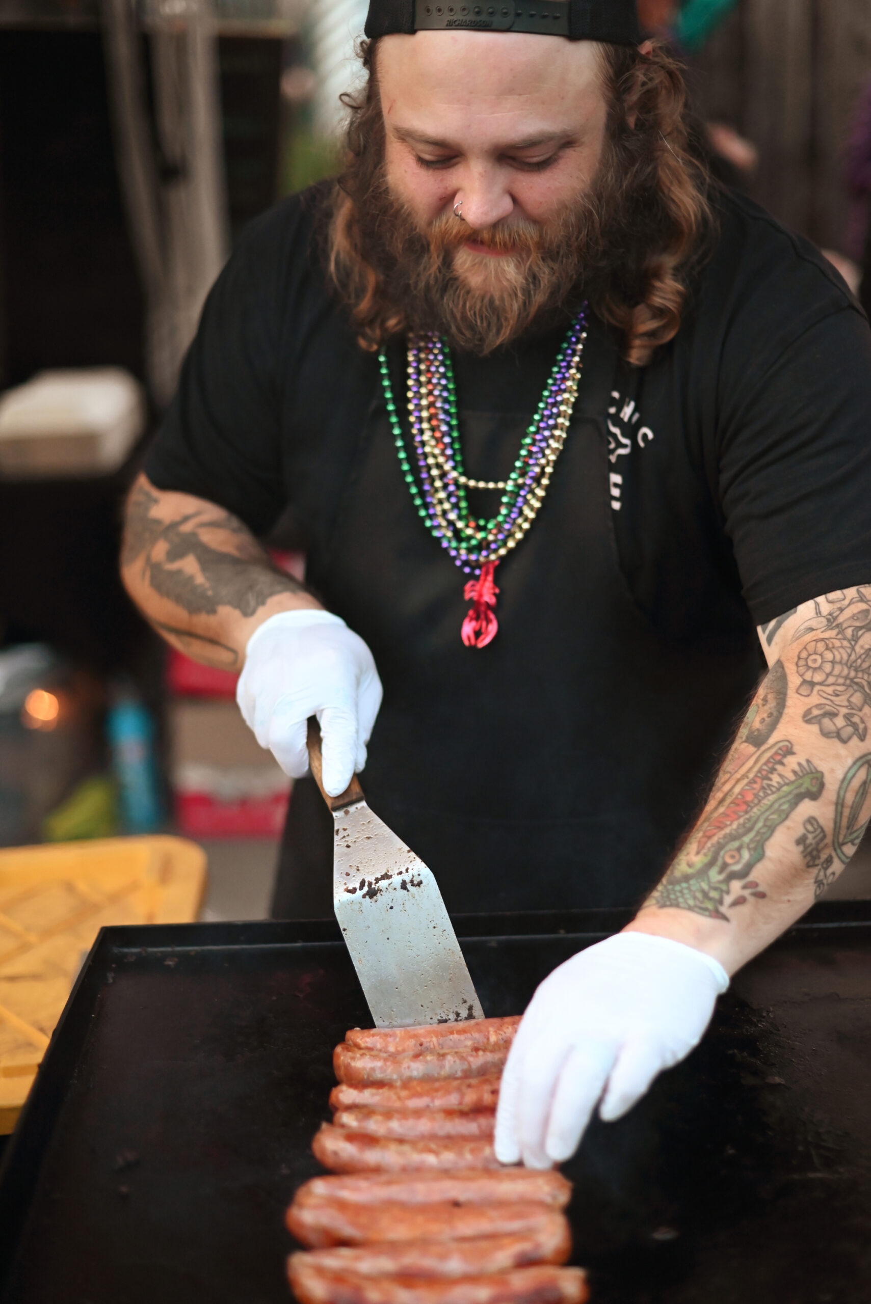 Bradley Wildridge of Bayou On The Bay grilling cajun sausages during the Petaluma Music Festival's 11th annual Mardi Gras Party at Lagunitas Brewing Co. Taproom and Sanctuary in Petaluma Tuesday, March 4, 2025. (Erik Castro / For The Press Democrat)