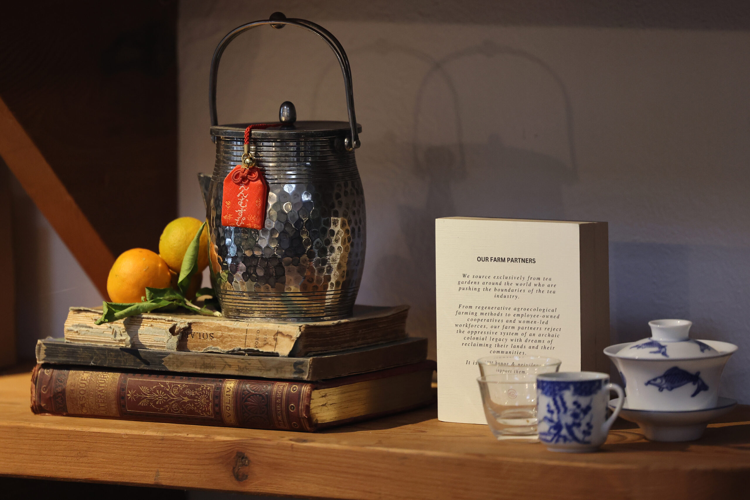 A traditional Chinese tea kettle sits on display with an information placard about the producers of the tea sourced by Two Trees Tea House in Occidental Wednesday, Feb. 12, 2025. (Beth Schlanker / The Press Democrat)