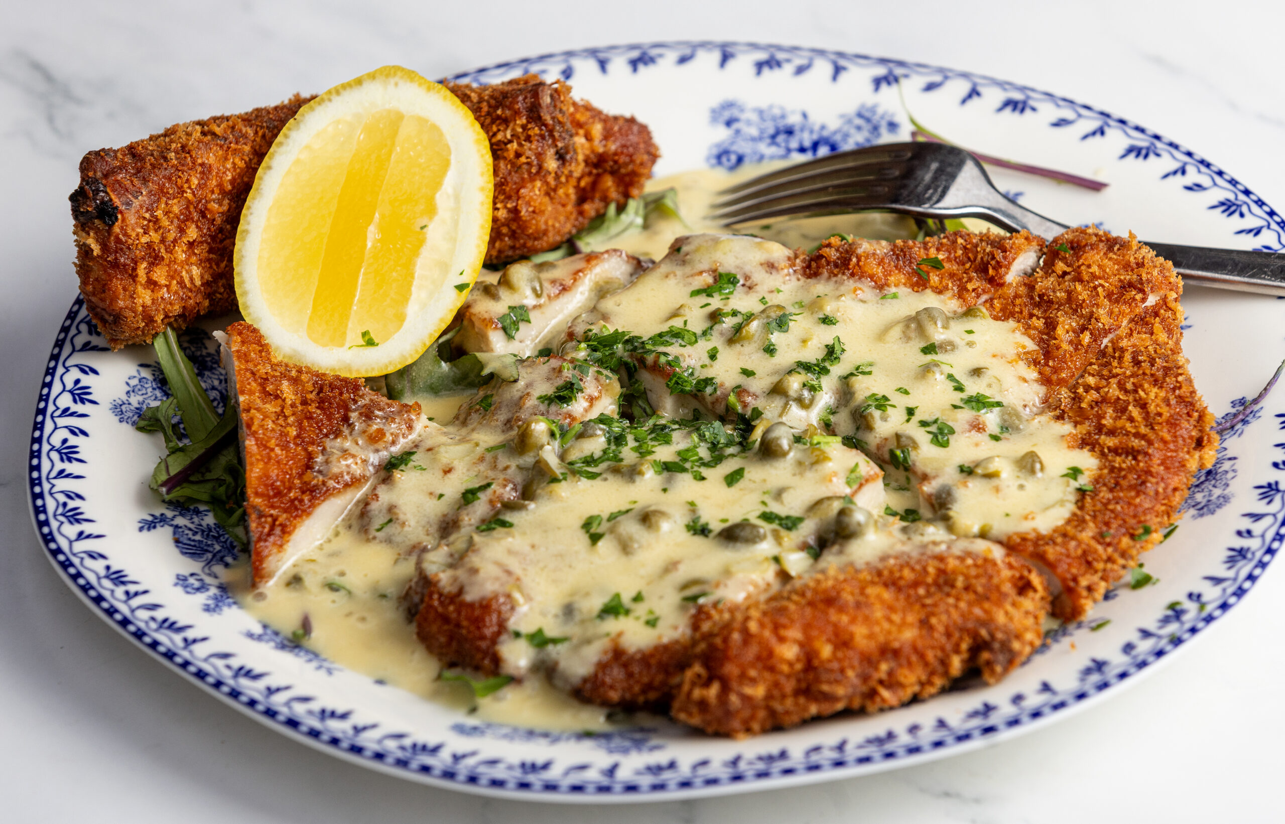 Duroc Pork Chop Milanese with lemon caper butter sauce from Stella Wednesday, March 26, 2025, in Kenwood. (John Burgess / The Press Democrat)