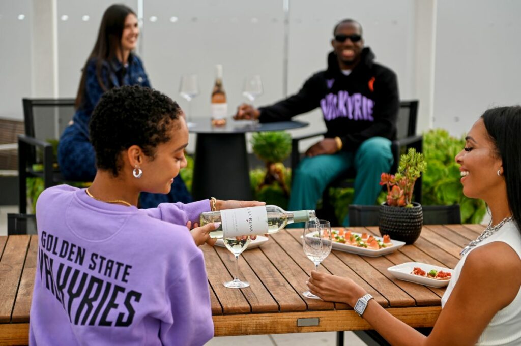 Folks drinking La Crema and wearing Valkyries gear