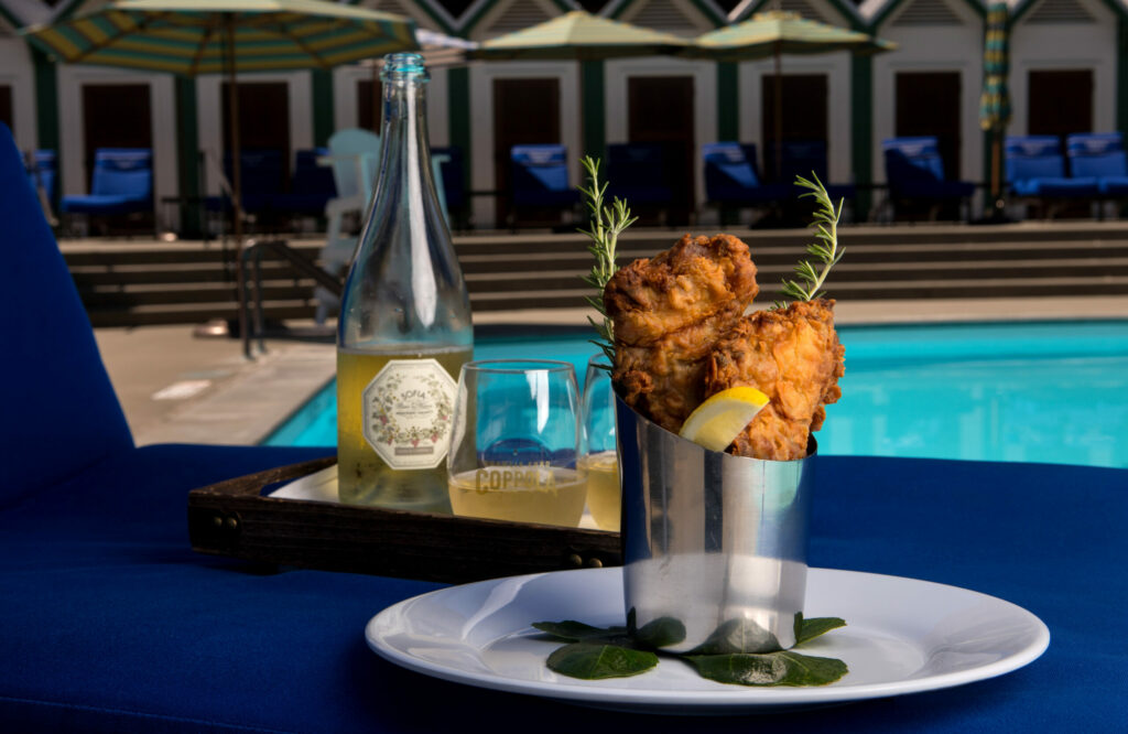 Cold fried chicken is shown poolside as Executive Chef Tim Bodell presents some of his personal dishes that he makes only for family and friends, at Francis Ford Coppola Winery, Tuesday, July 25, 2023 in Geyserville. (Darryl Bush / For The Press Democrat)