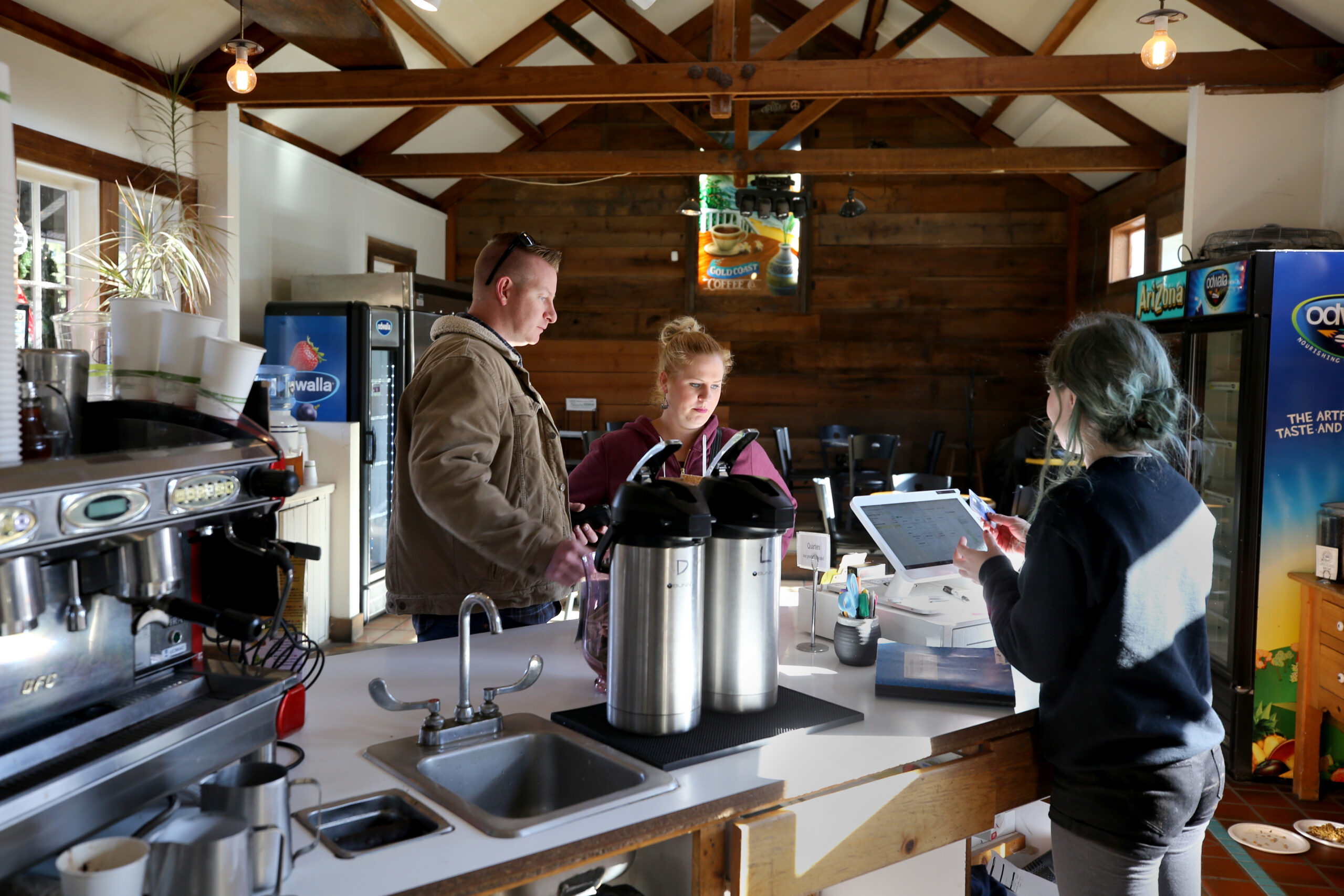 Nate Feil and his wife Shelley place their order with employee Kenzie Stevens at Gold Coast Coffee and Bakery in Duncans Mills on Monday, November 25, 2019. (Beth Schlanker / The Press Democrat)