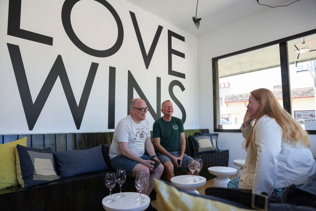 Equity Vines co-founder Jim Obergefell, left, talks with Daniel Potapshyn and Jenica Lancy, of the Golden West Chapter of The ALS Association, at his tasting room in Guerneville, Thursday, July 13, 2023. (Christopher Chung / The Press Democrat)