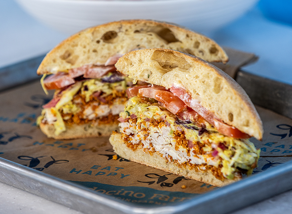 The “Not So Fried Chicken” Sandwich with Mendo’s krispies, herb aioli, mustard pickle slaw, tomatoes and pickled red onions on toasted ciabatta from Mendocino Farms Tuesday, May 13, 2025 in Santa Rosa’s Montgomery Village. (John Burgess / The Press Democrat)