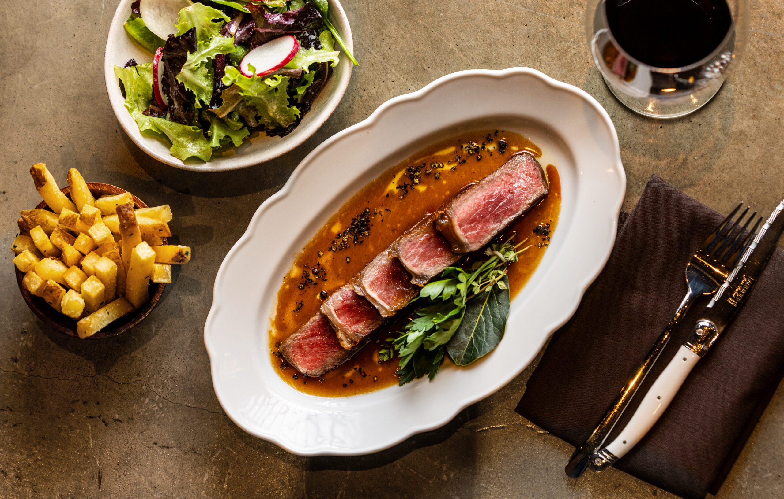 Steak & Frites with sauce au Poivre, beef jus and garden salad from Bijou, the new Petaluma restaurant from chef Stéphane Saint Louis Monday, July 1, 2025. (John Burgess / The Press Democrat)
