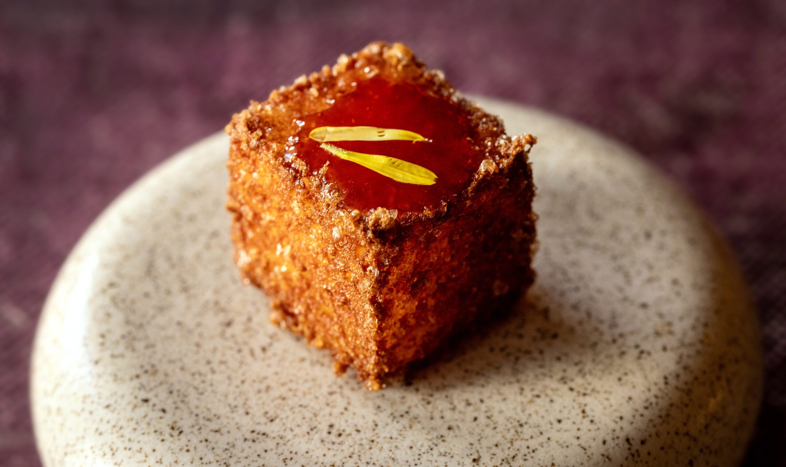 Dahlinho de Tapioca, fried bite with aged gouda, parmigiana and chili jam from the new prix fixe tasting menu at The Lodge at Dawn Ranch Thursday, September 4, 2025 in Guerneville. (John Burgess / The Press Democrat)