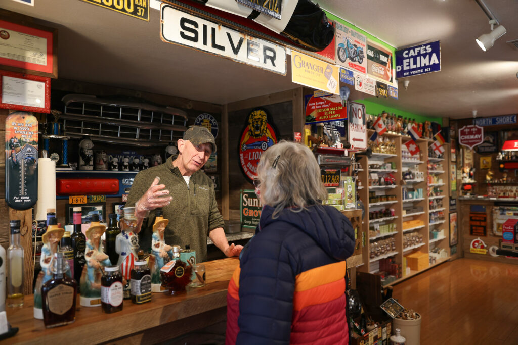 Steinhouse owner Eric Dewit, left, talks to customer Gail Vann about chocolates while offering samples at his Santa Rosa shop on Friday, February 7, 2025. (Christopher Chung/The Press Democrat)