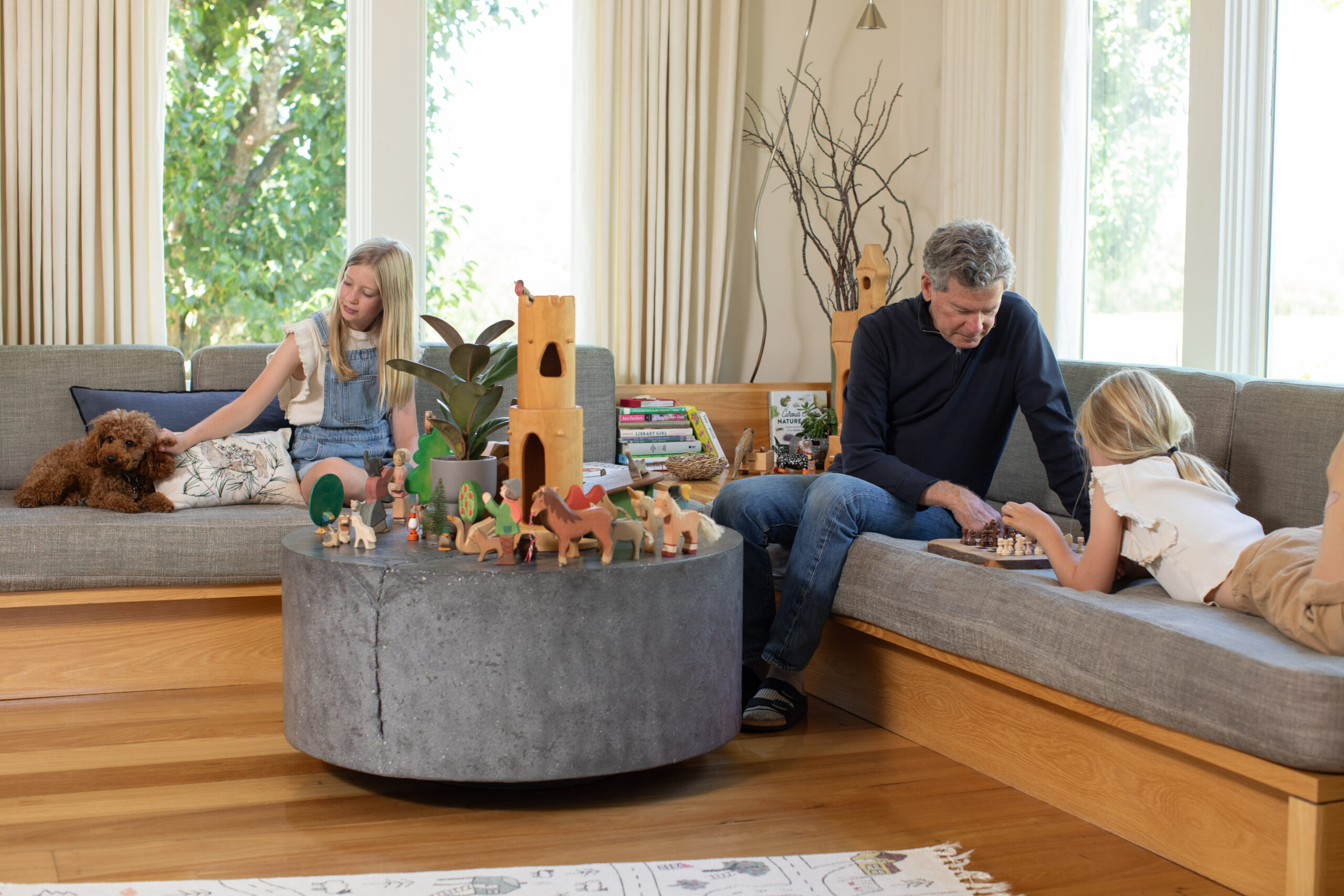 Winemaker Paul Hobbs and daughters Sophia and Louisa lounge and play in their west county home. (Eileen Roche / for Sonoma Magazine)