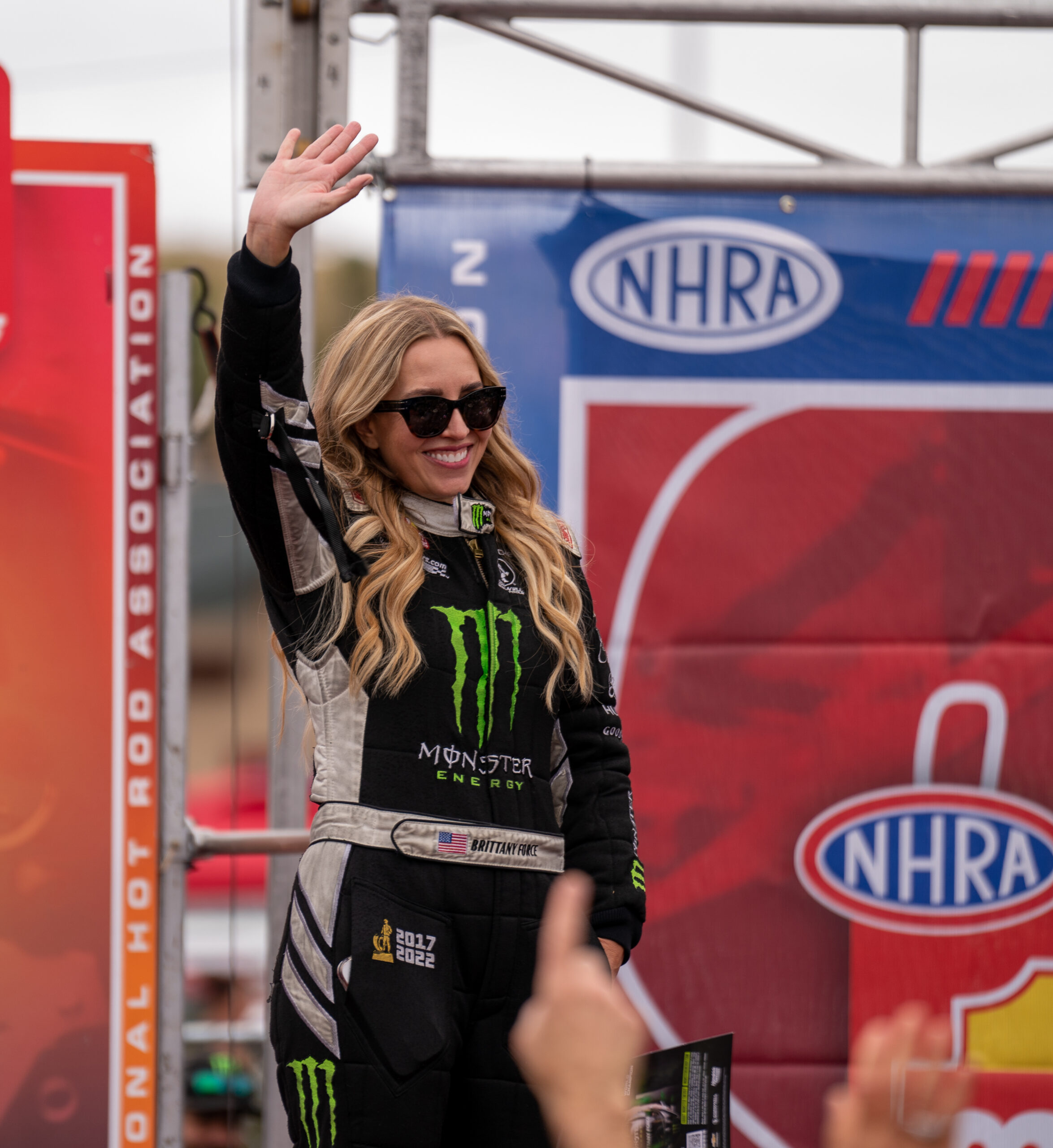 Top Fuel driver Brittany Force waves at fans as she walks out onto the Mission Foods Series stage at the DENSO NHRA Sonoma Nationals on Sunday, July 27, 2025 in Sonoma. (Nicholas Vides / For The Press Democrat)
