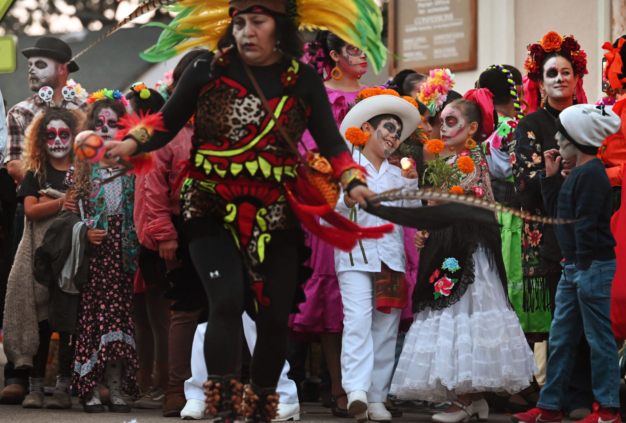 Attendees watching Aztec dancers before the start of El Día de los Muertos candlelight process at the St. Vincent de Paul Church in Petaluma on Saturday, Oct. 26, 2024. (Erik Castro / For The Press Democrat)