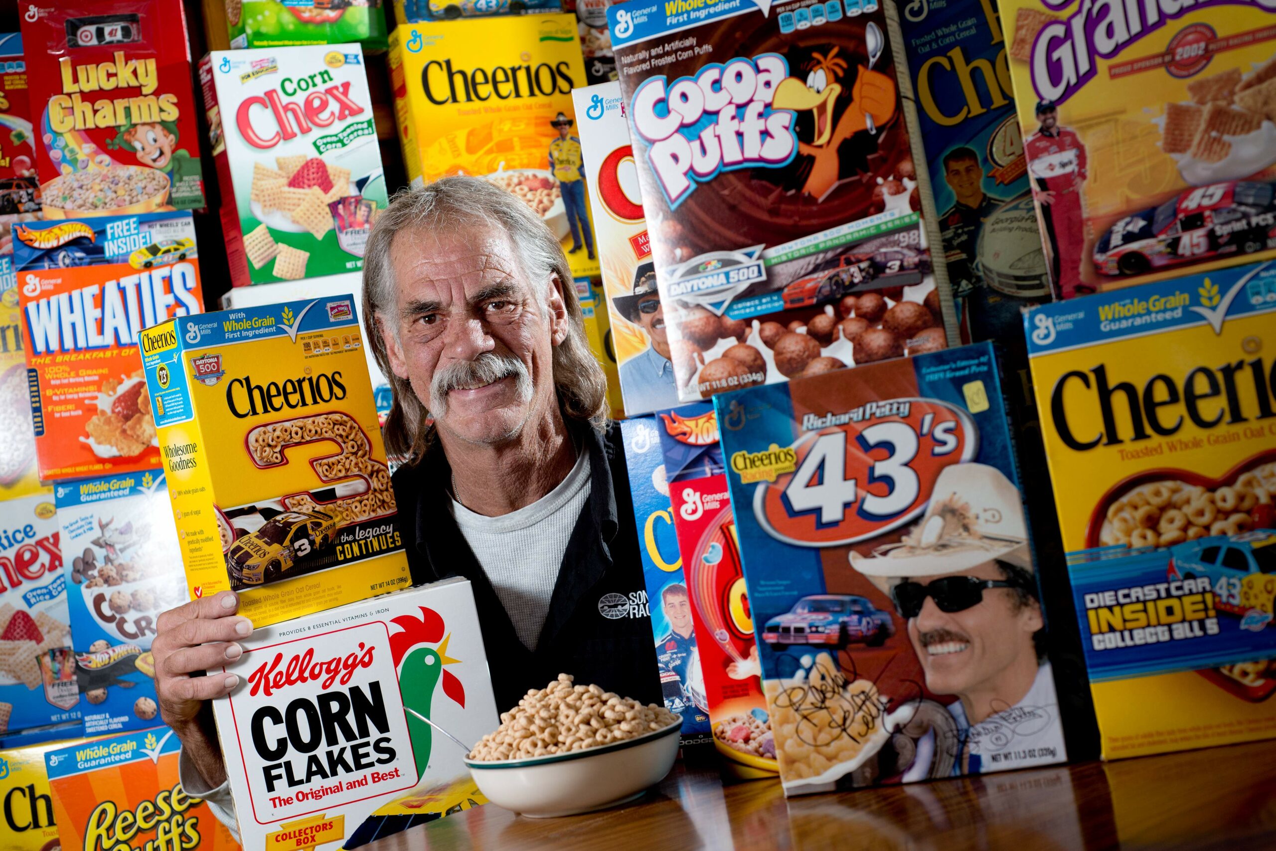 Randy Ricci, collector of over 300 NASCAR-themed cereal boxes, sits among a fraction of his collection at his home in Santa Rosa on February 21, 2014. (Alvin Jornada / The Press Democrat)