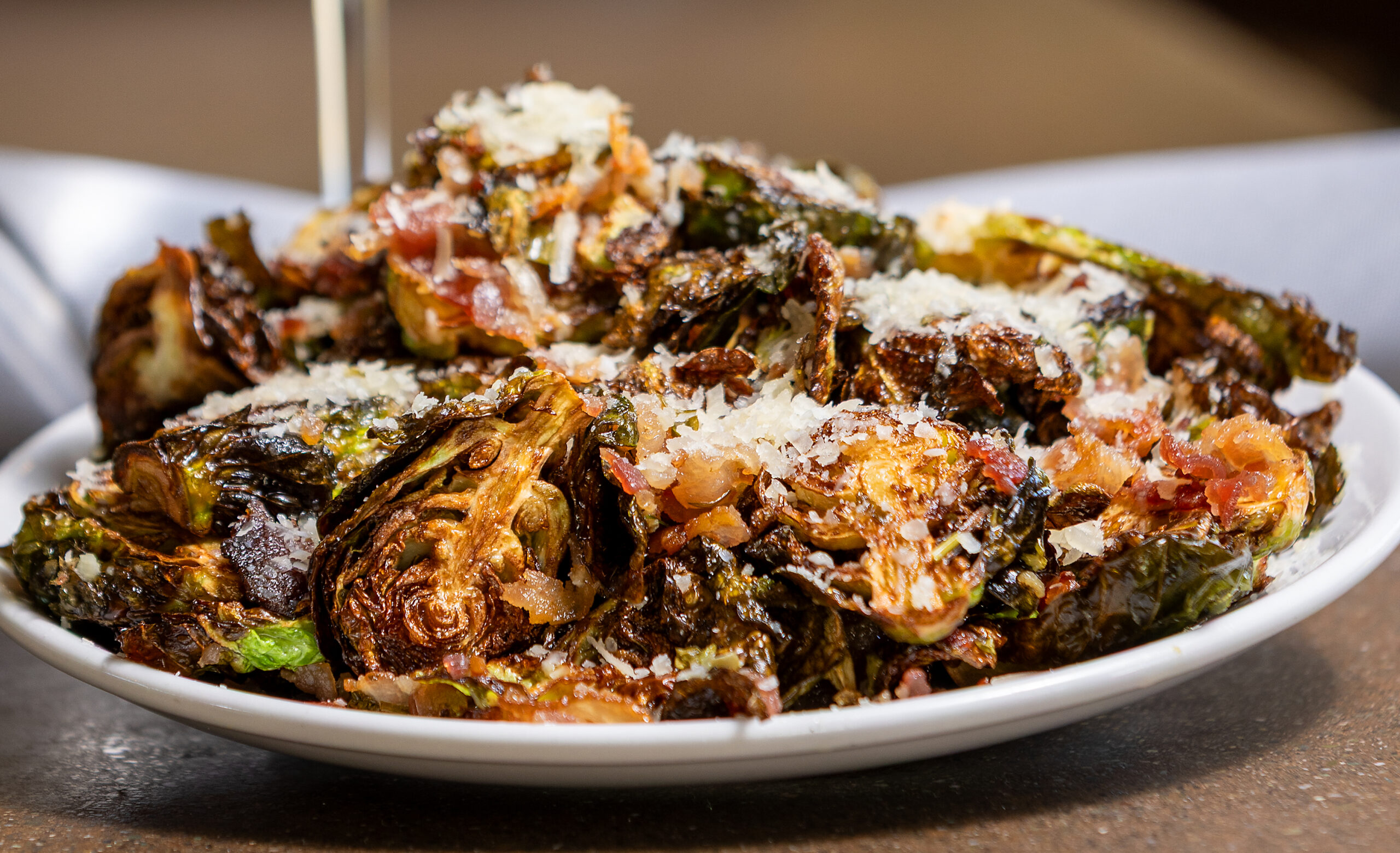 Fried Brussels Sprouts with Applewood bacon, lemon vinaigrette and Parmigiano Reggiano from Hazel restaurant Thursday, July 10, 2025 celebrating 10 years in Occidental. (John Burgess / Press Democrat)