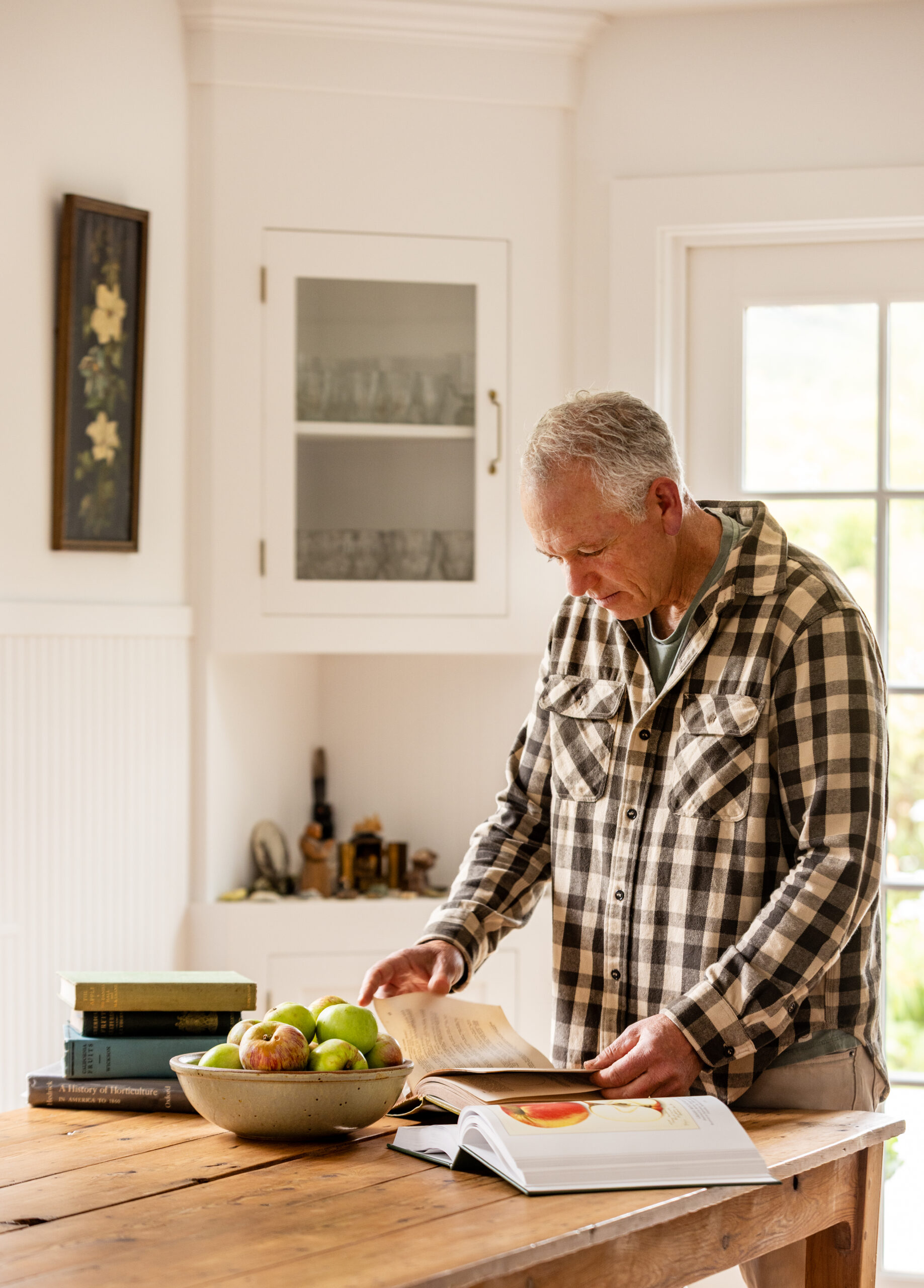 Dan Lehrer, a co-owner of Little Apple Treats, has collected historical books on apples from around the work and believes their is a second “Nova Scotia” variety of Sonoma County's much loved Gravenstein Apple Thursday July 24, 2025 in Sebastopol. (John Burgess / The Press Democrat)