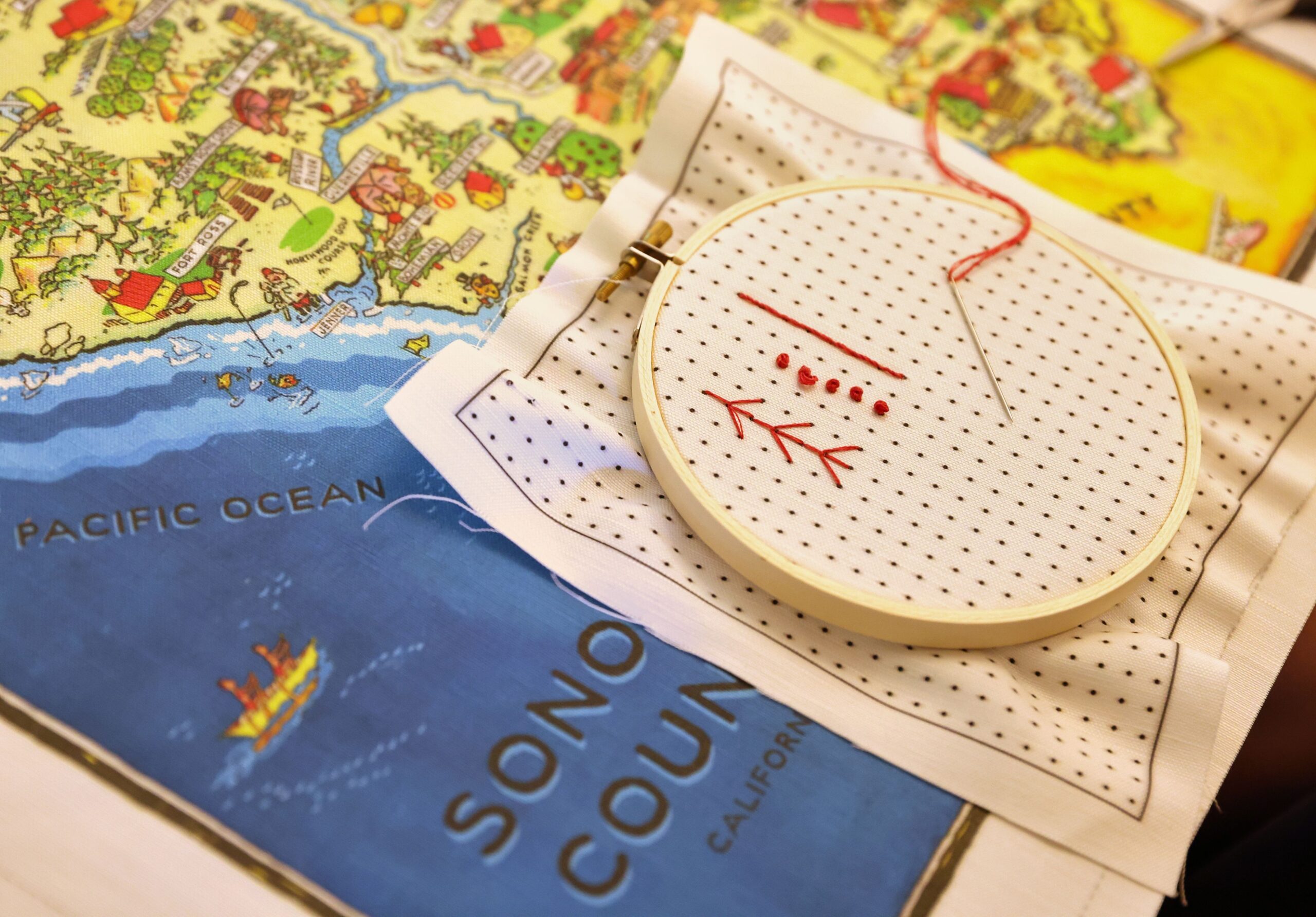 A student’s practice stitches lay on top of a cloth Sonoma County map that will be used for embroidery at Robert Mahar’s craft retreat at Westerbeke Ranch in Sonoma on Tuesday, September 16, 2025. (Christopher Chung/The Press Democrat)
